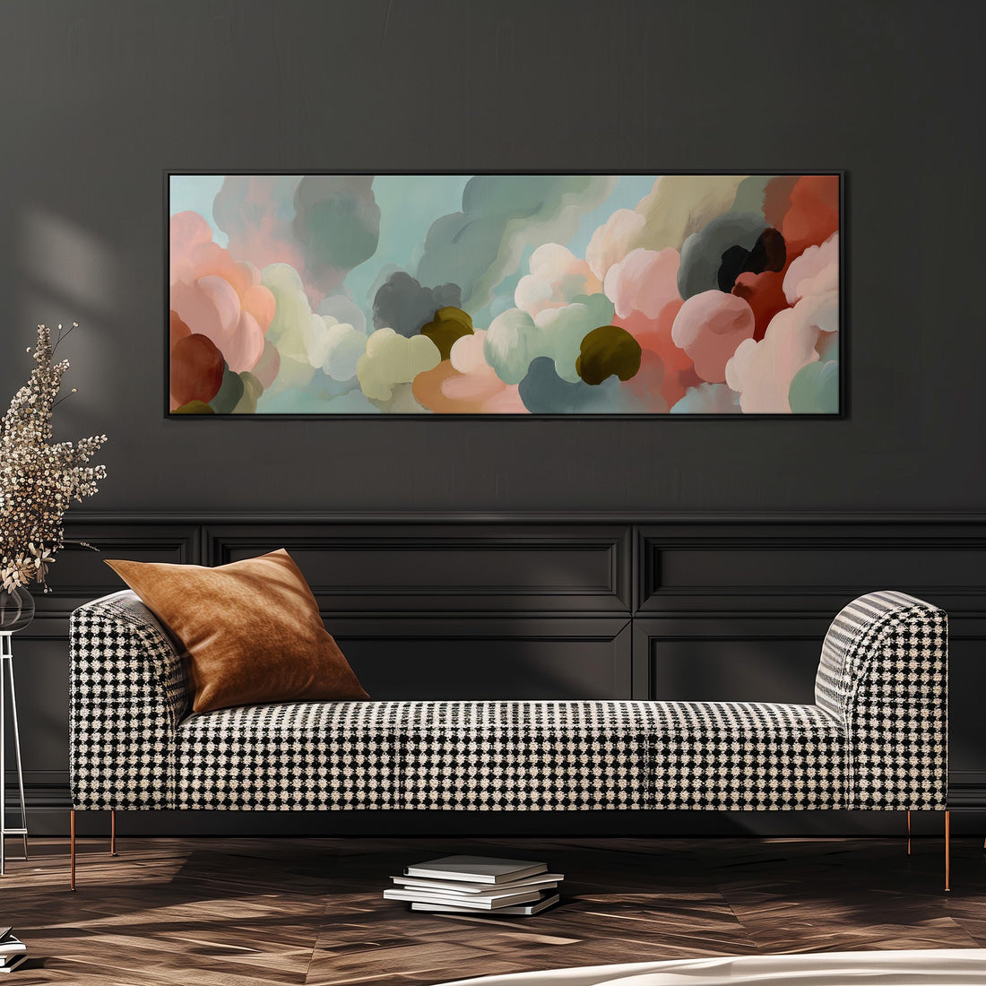 a modern living room with a black and white checkered sofa, a stack of books, and a large abstract painting hanging on the wall above the sofa.