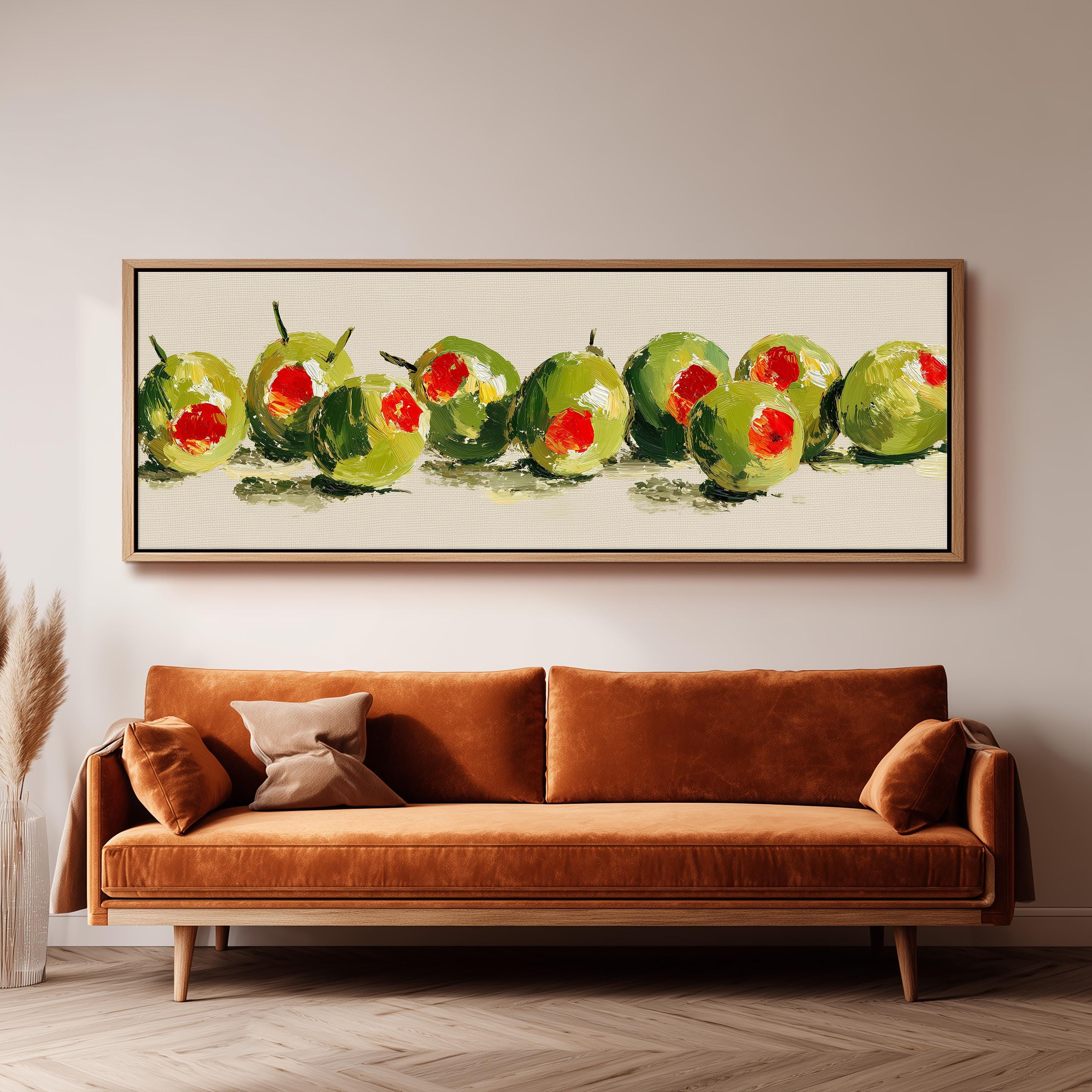 a large painting of green olives hanging on a wall above a brown sofa.