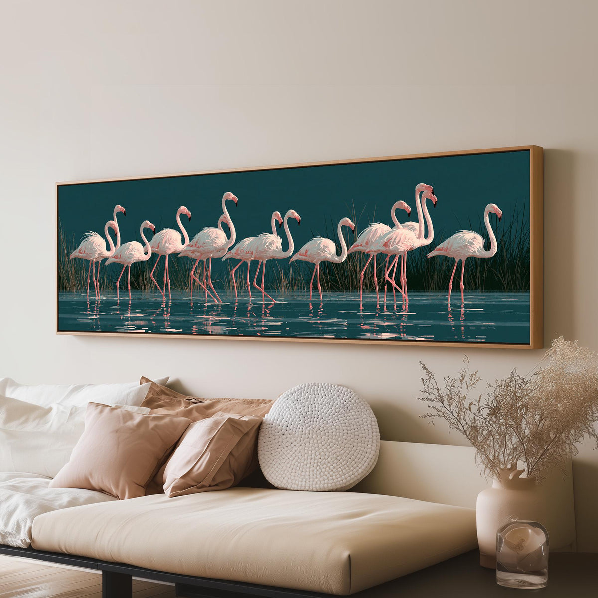 Blush pink flamingos on dark teal water panoramic canvas print above a sofa in a living room