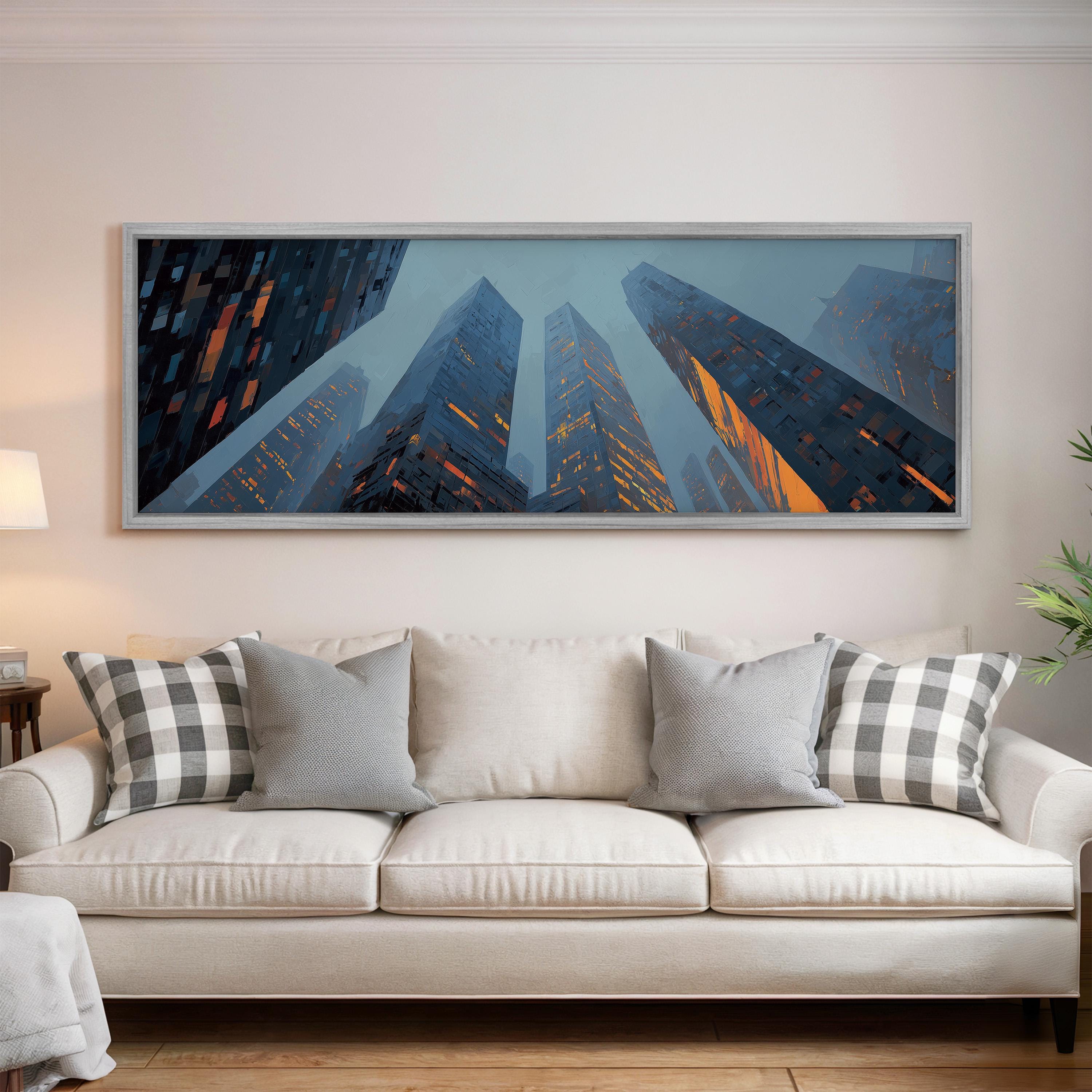 a large, framed painting of a cityscape with tall buildings and a blue sky with orange and yellow lights, hanging on a wall above a white couch with patterned throw pillows.
