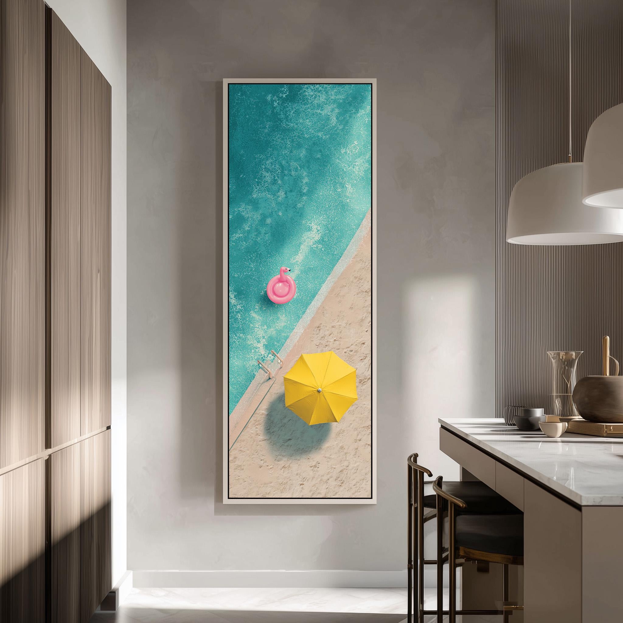 a large framed painting hanging on a wall, depicting a beach scene with a pink inflatable object and a yellow umbrella.