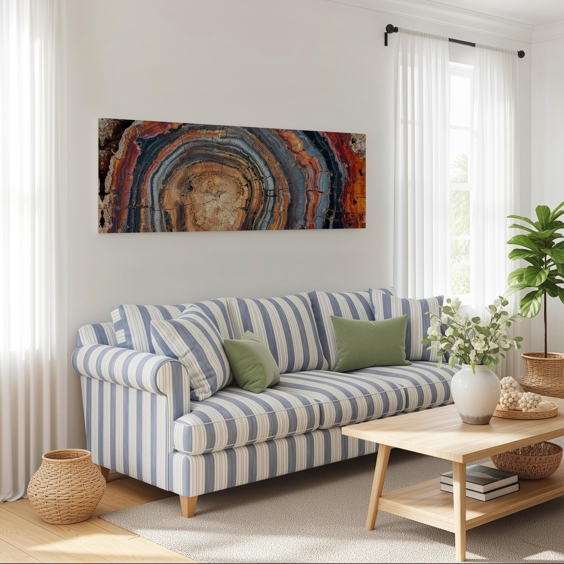 a cozy living room with a striped blue and white sofa, a wooden coffee table, and a large abstract painting on the wall.