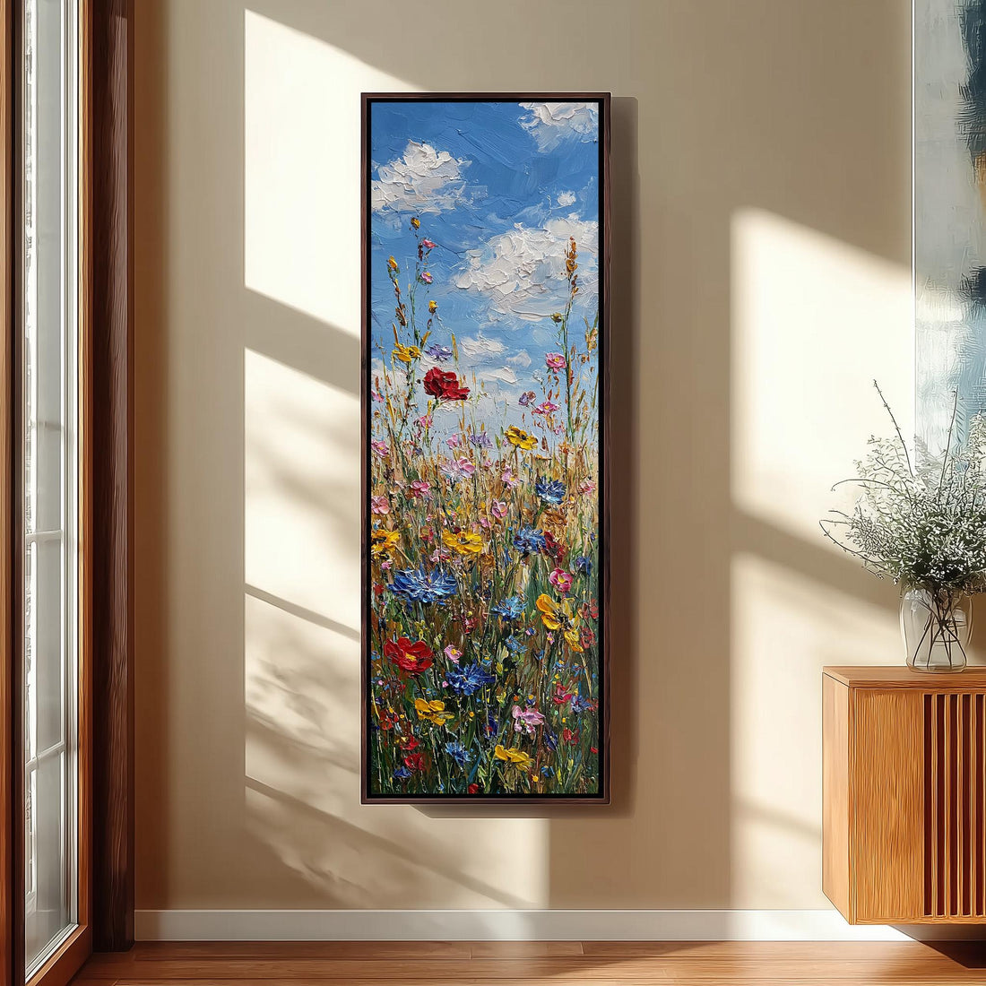 a large, colorful painting of a field of flowers hanging on a wall.