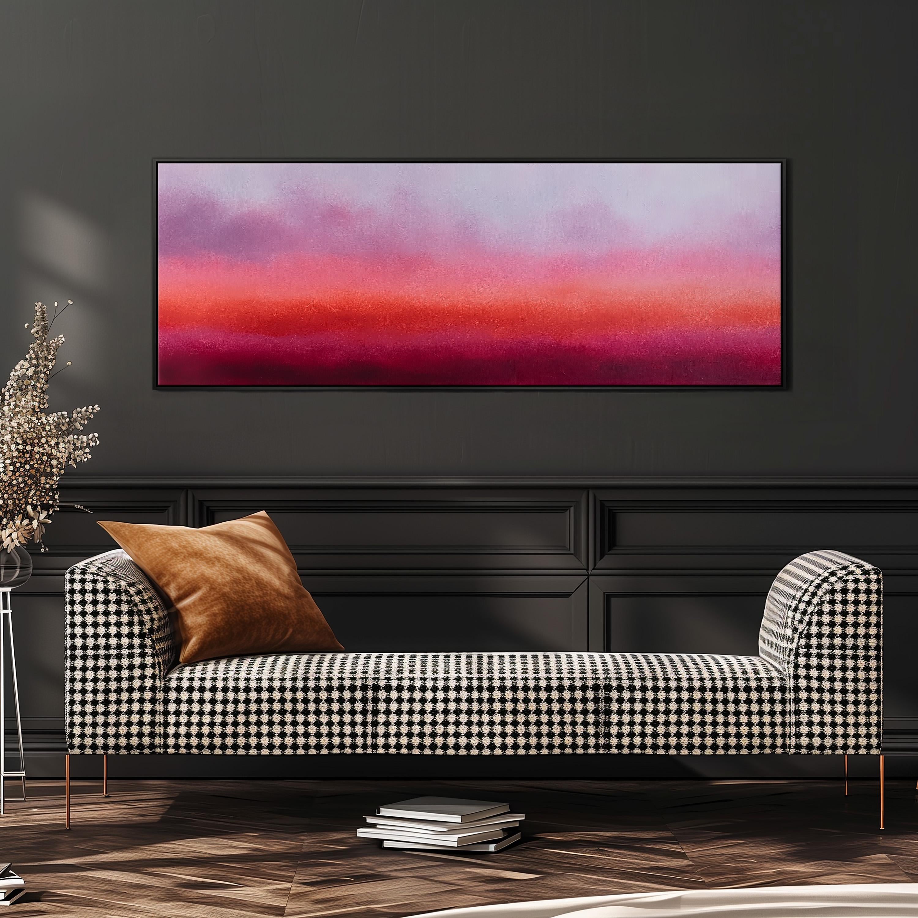a modern living room with a black and white checkered sofa, a stack of books, and a large abstract painting on the wall.