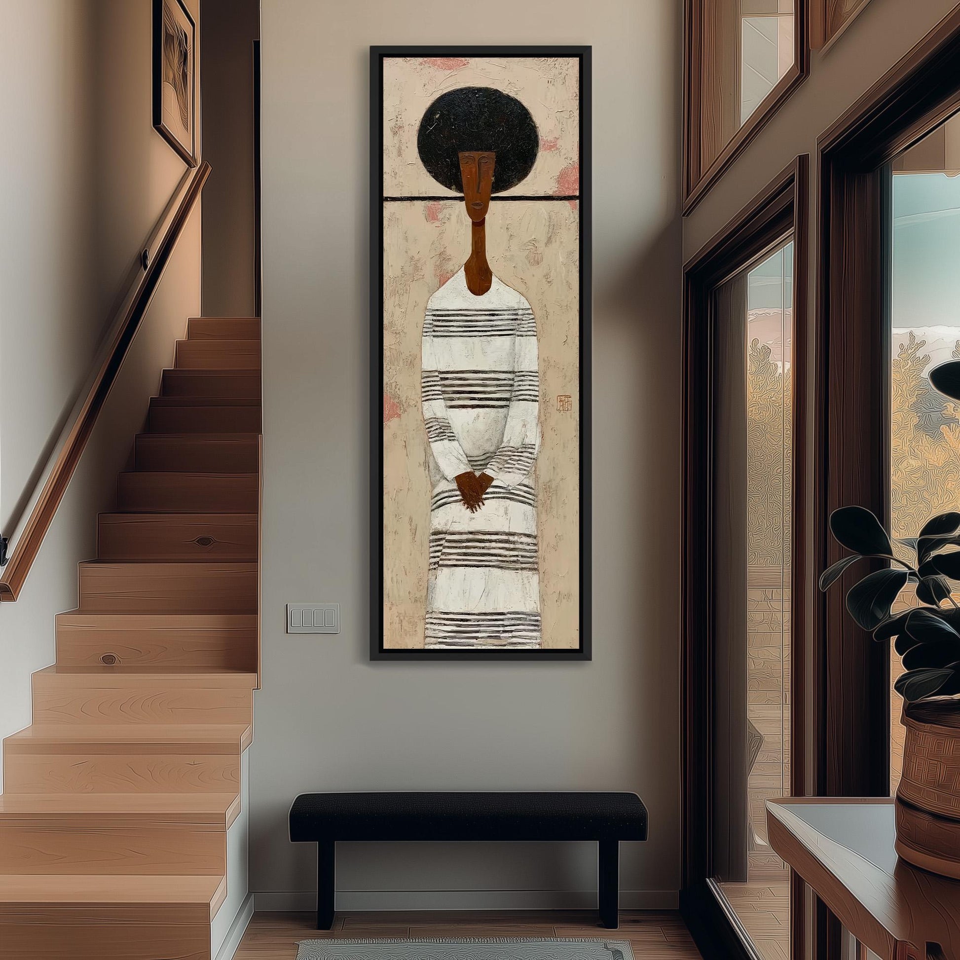 a large painting of a woman with a black afro hairstyle, hanging on a wall in a hallway. The painting is framed and appears to be the focal point of the room.