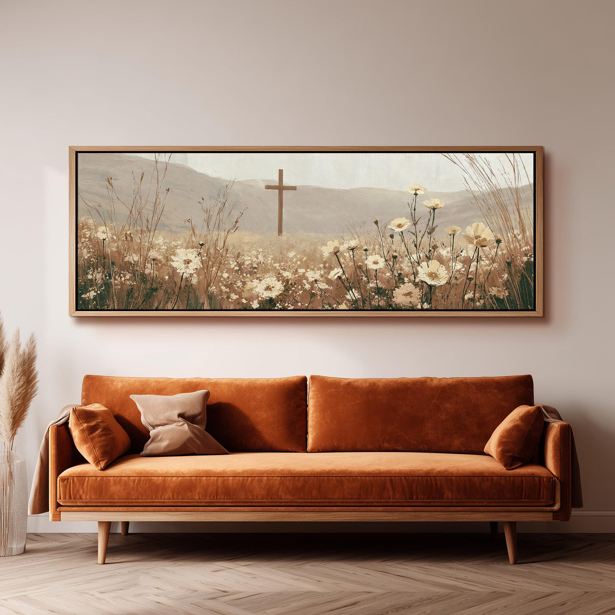 Wooden cross in a cream wildflower field panoramic canvas print above a sofa in a living room