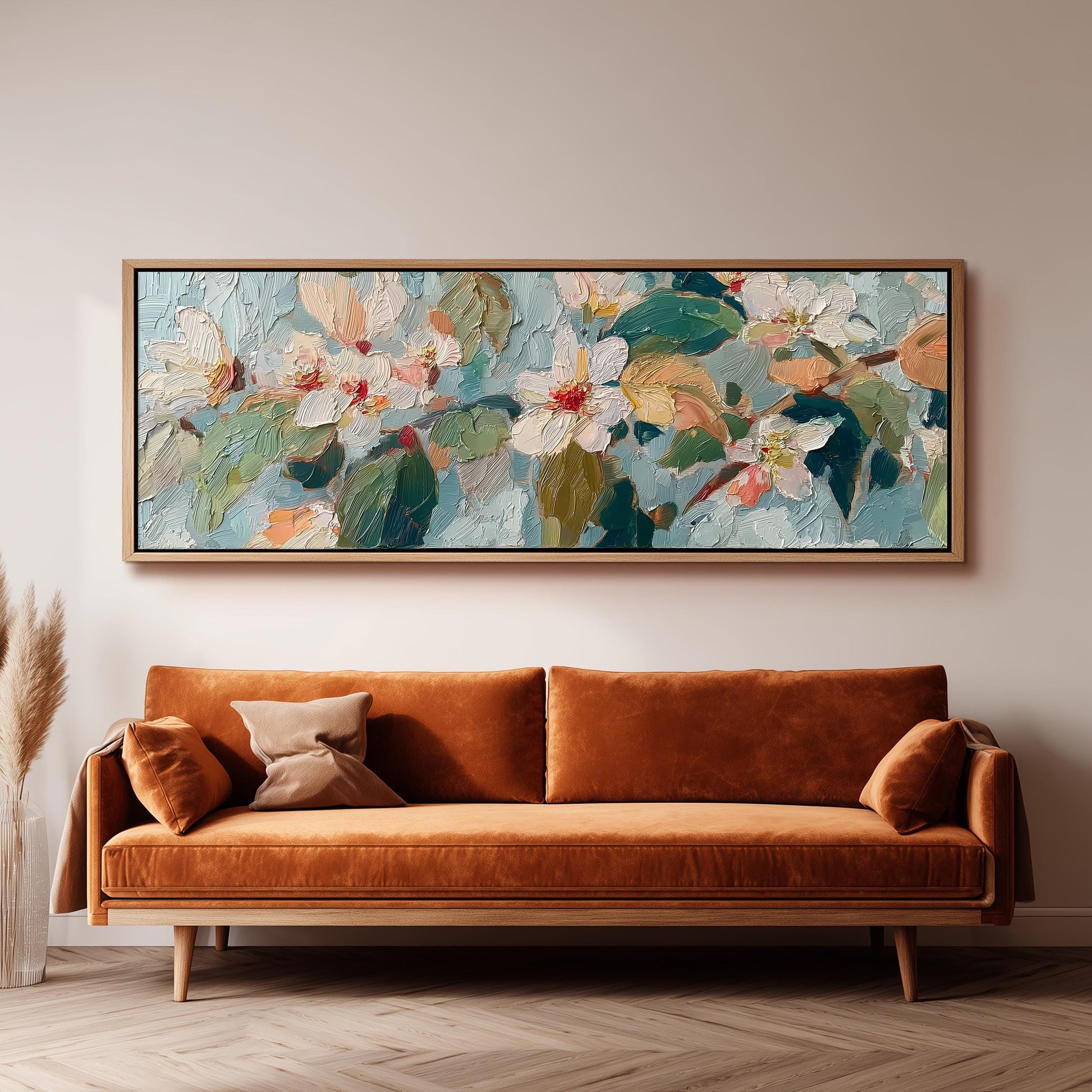 a large, colorful painting of flowers hanging on a wall above a brown sofa.