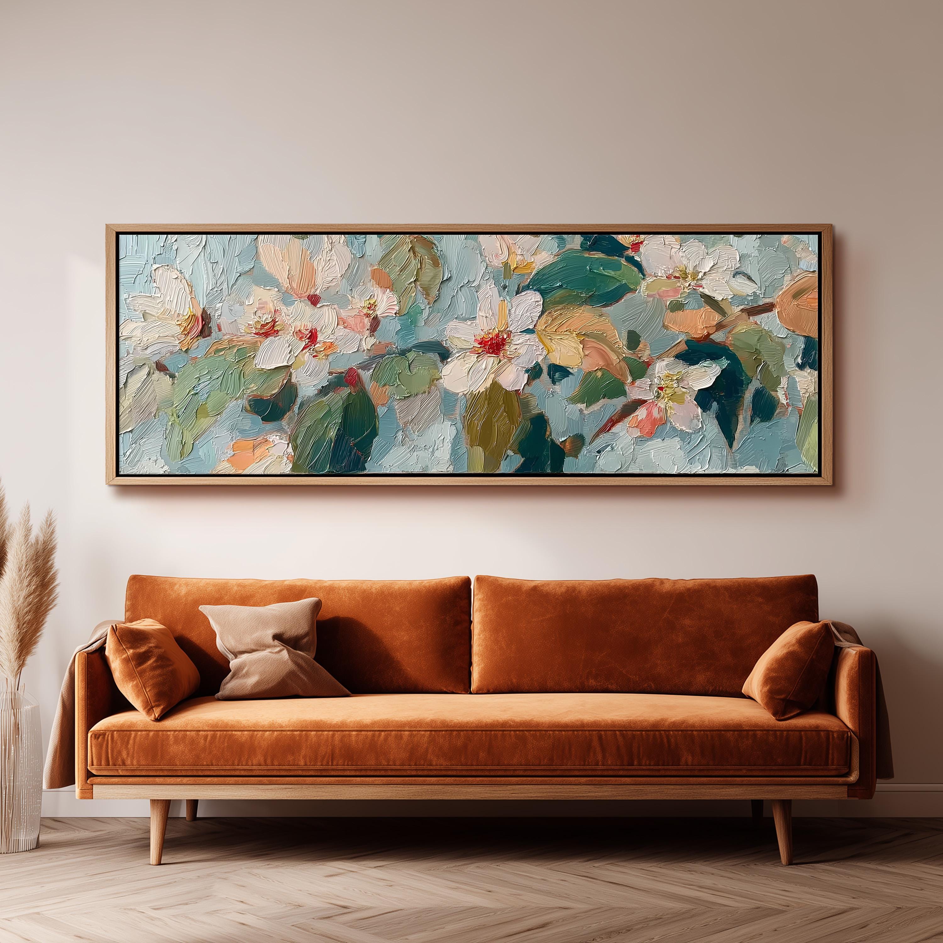 a large, colorful painting of flowers hanging on a wall above a brown sofa.