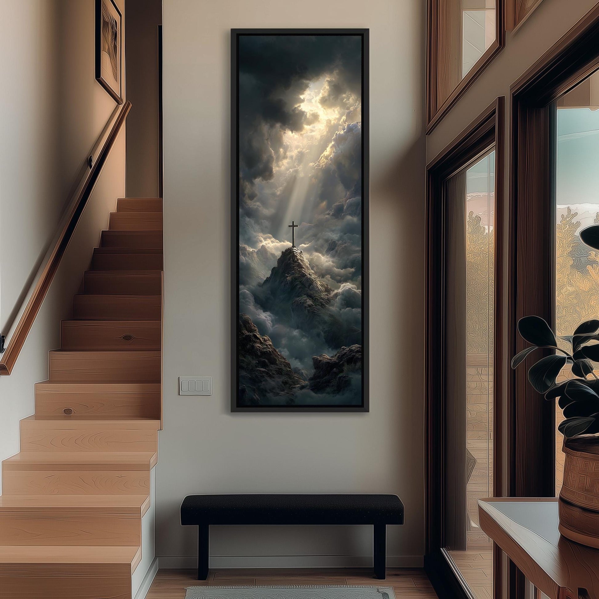 a large, framed painting of a mountain landscape with a cross on top, hanging on a wall in a hallway.
