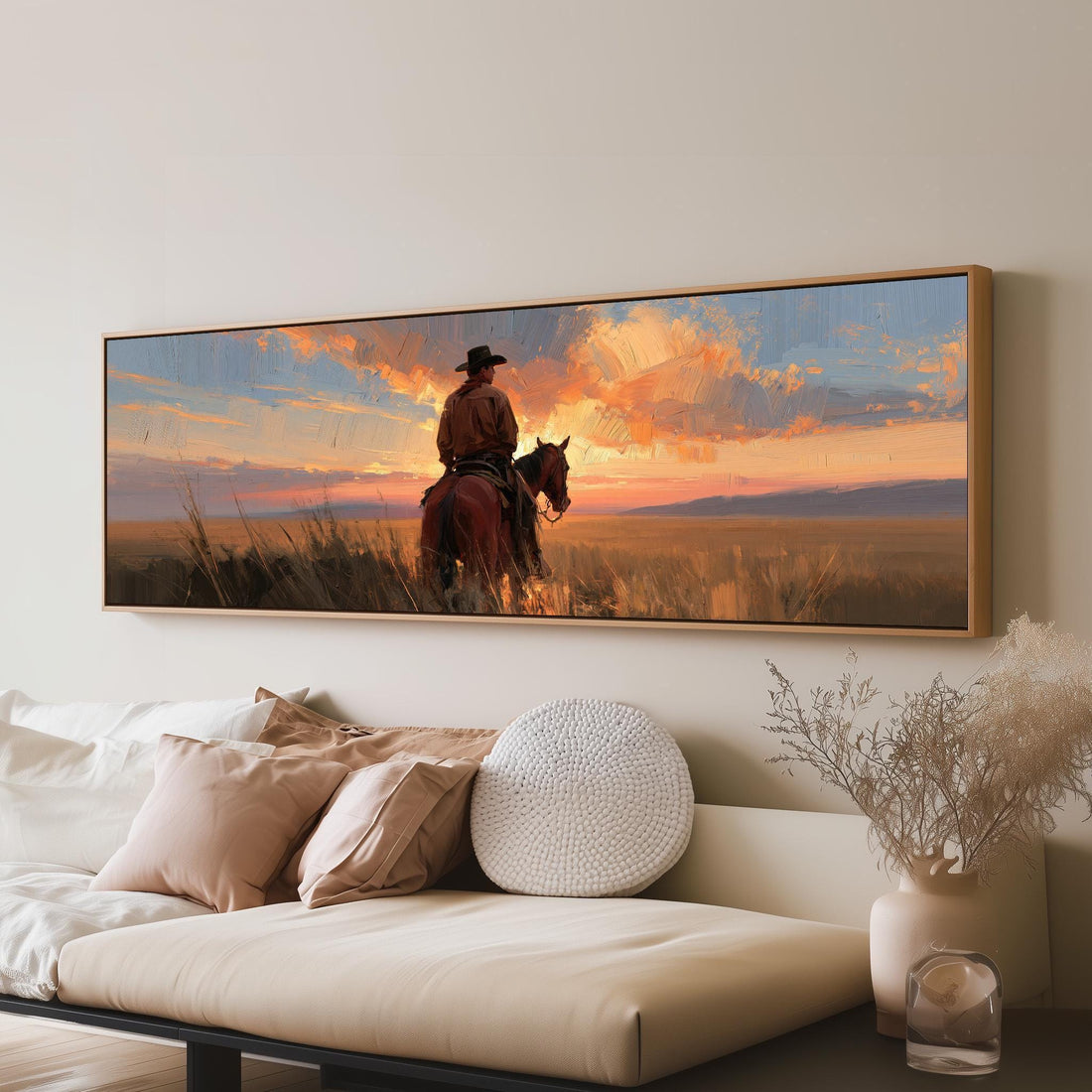 Cowboy on horseback at a golden sunset long horizontal canvas print above a sofa in a living room