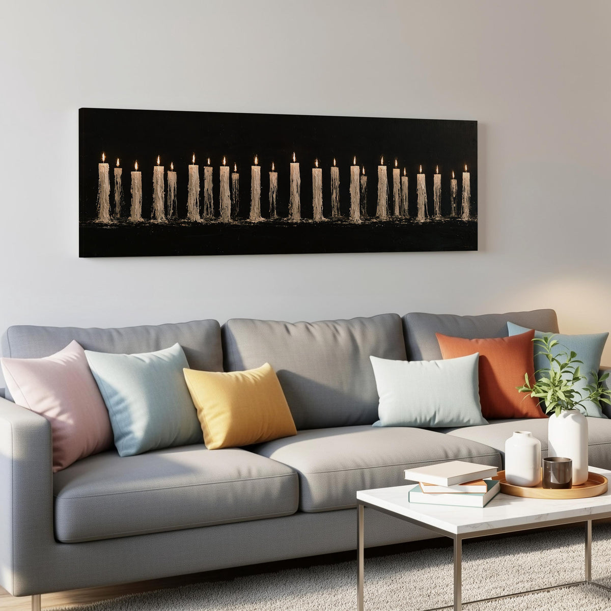 Long row of flickering candles panoramic canvas print above a grey sofa in a living room