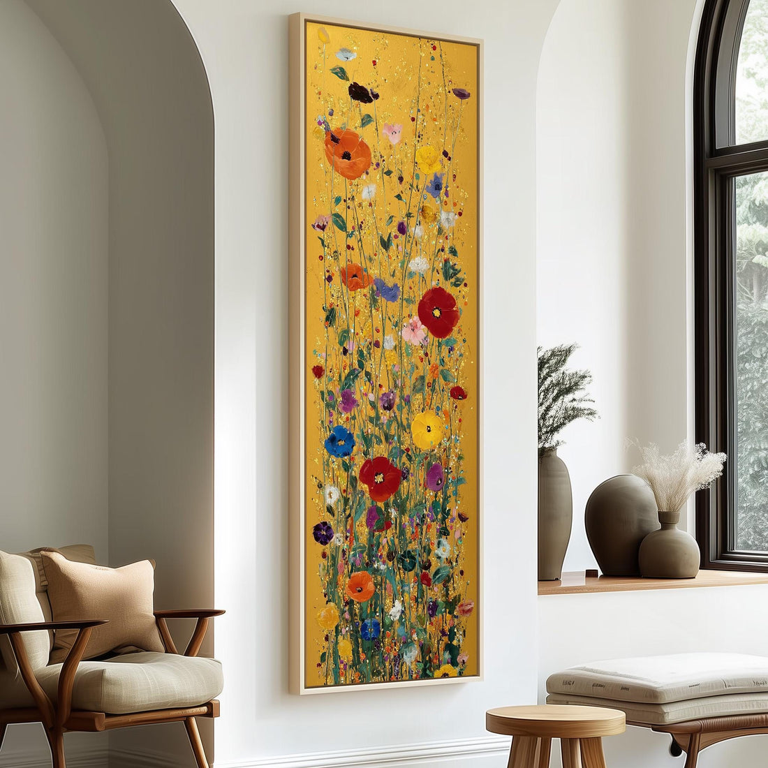 a large, colorful painting of flowers hanging on a wall in a room with a wooden chair and a small table.