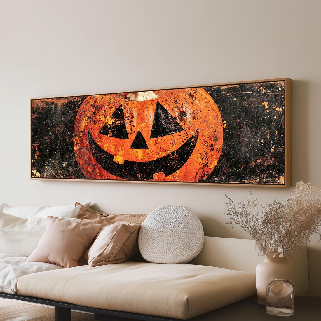 Rustic distressed jack-o'-lantern long horizontal canvas print above a sofa in a living room