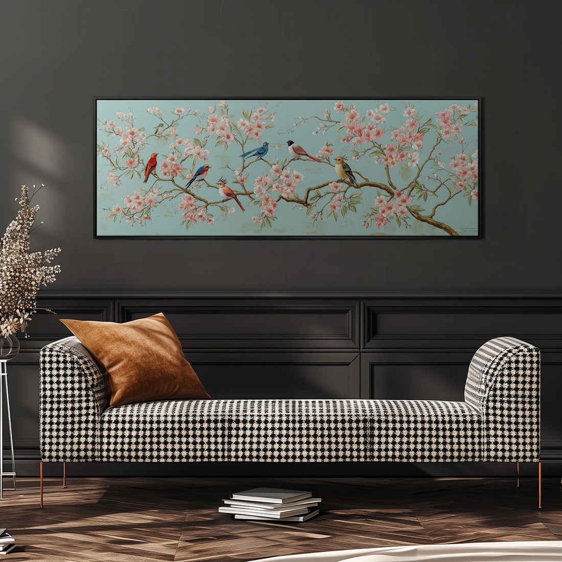 a large, framed painting of a cherry blossom tree with birds perched on its branches, hanging on a wall above a brown sofa.