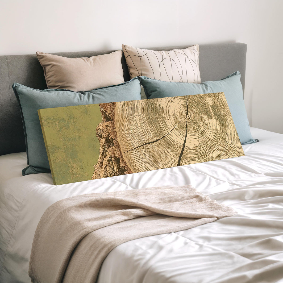Golden tree ring wood grain wide panoramic canvas print laid on a bed to show its size
