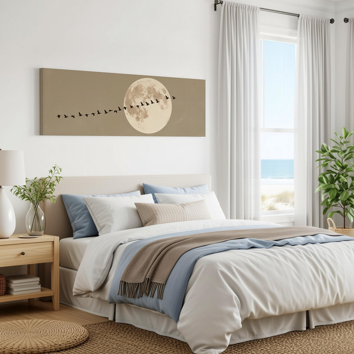 Geese flying past a full moon panoramic canvas print above a bed in a coastal bedroom