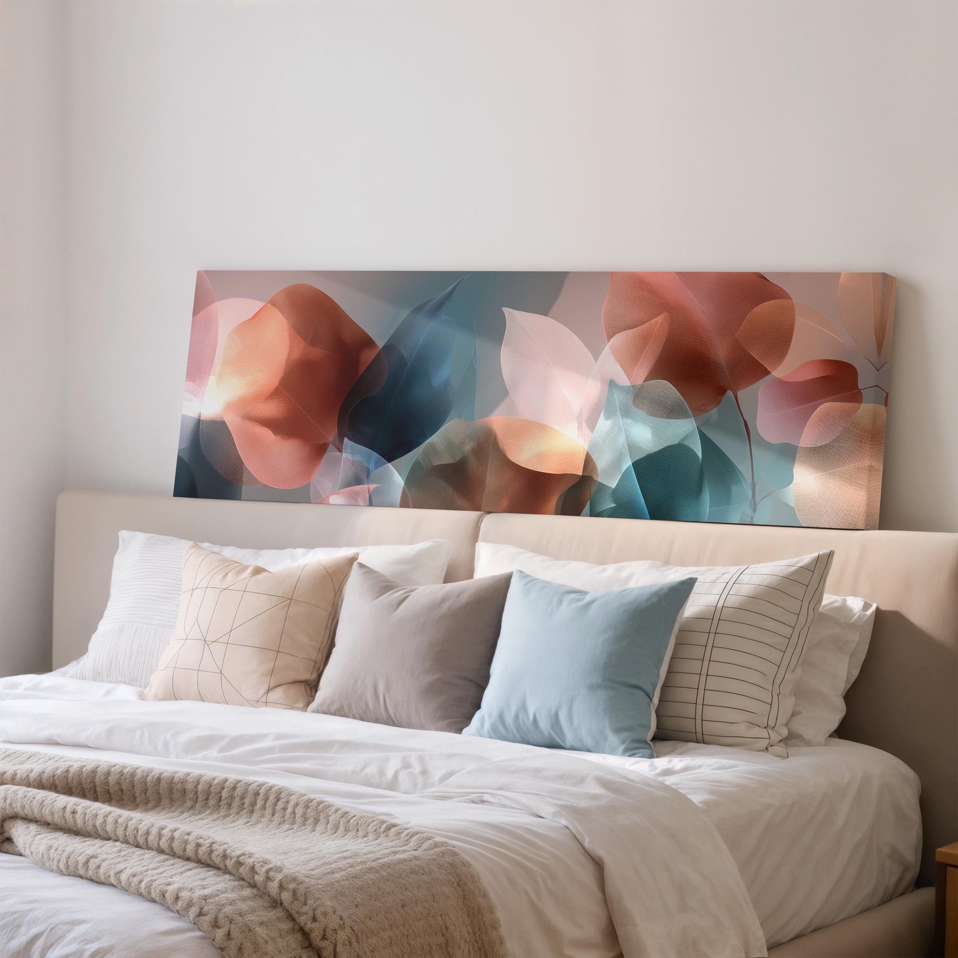 a large abstract painting hanging above a bed with white pillows and a gray blanket.