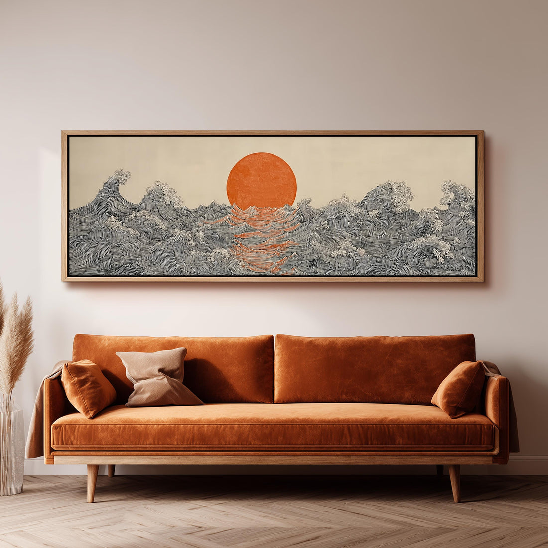 a large, framed artwork depicting a seascape with a sun and waves, hanging on a wall above a brown sofa.