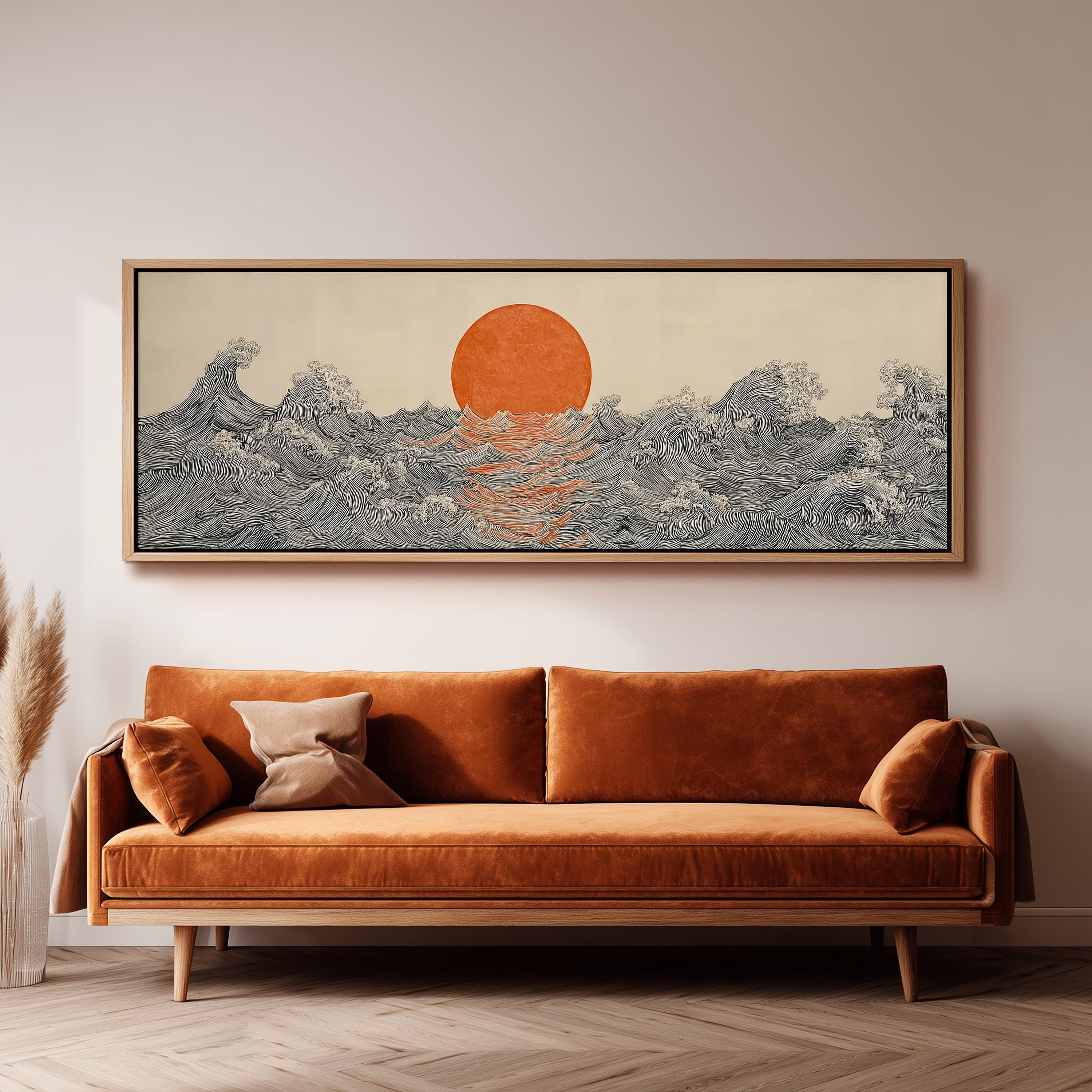 a large, framed artwork depicting a seascape with a sun and waves, hanging on a wall above a brown sofa.