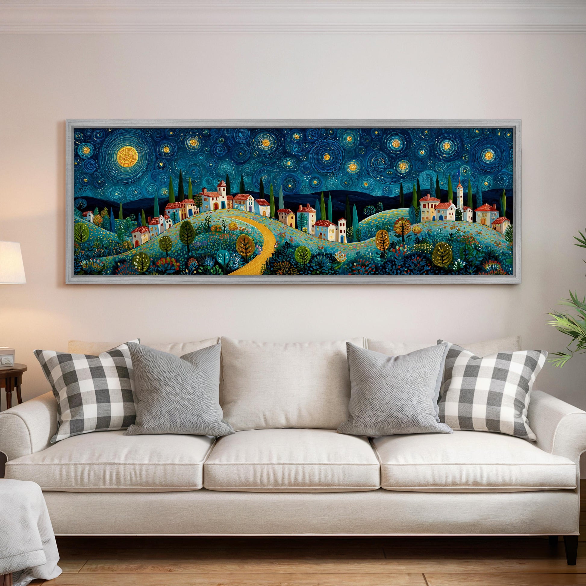 a large, colorful painting of a village scene hanging on a wall above a white couch in a living room.