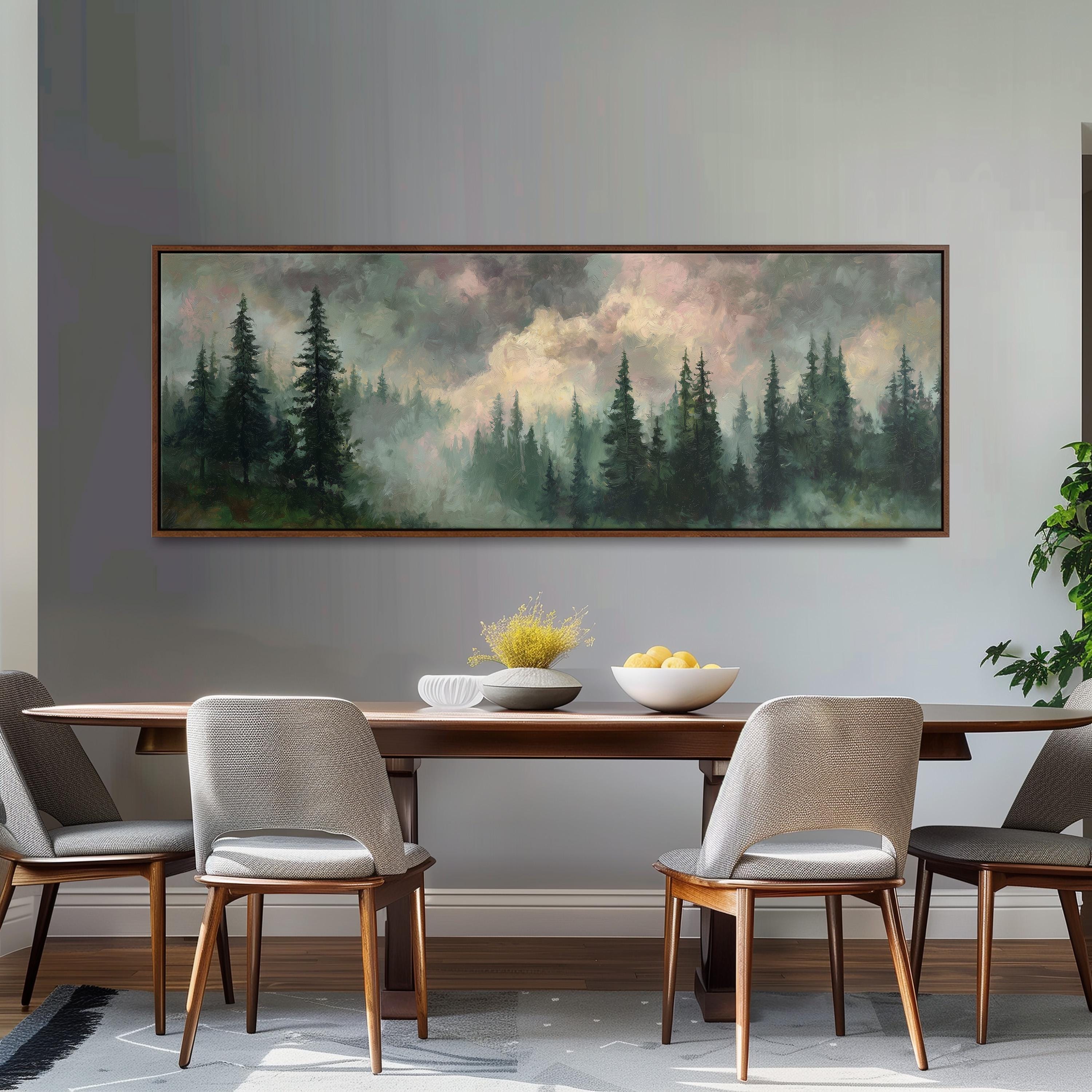 a dining room with a large painting of a forest scene hanging on the wall above a wooden dining table with four chairs. The painting depicts a misty forest landscape with tall trees and a cloudy sky.