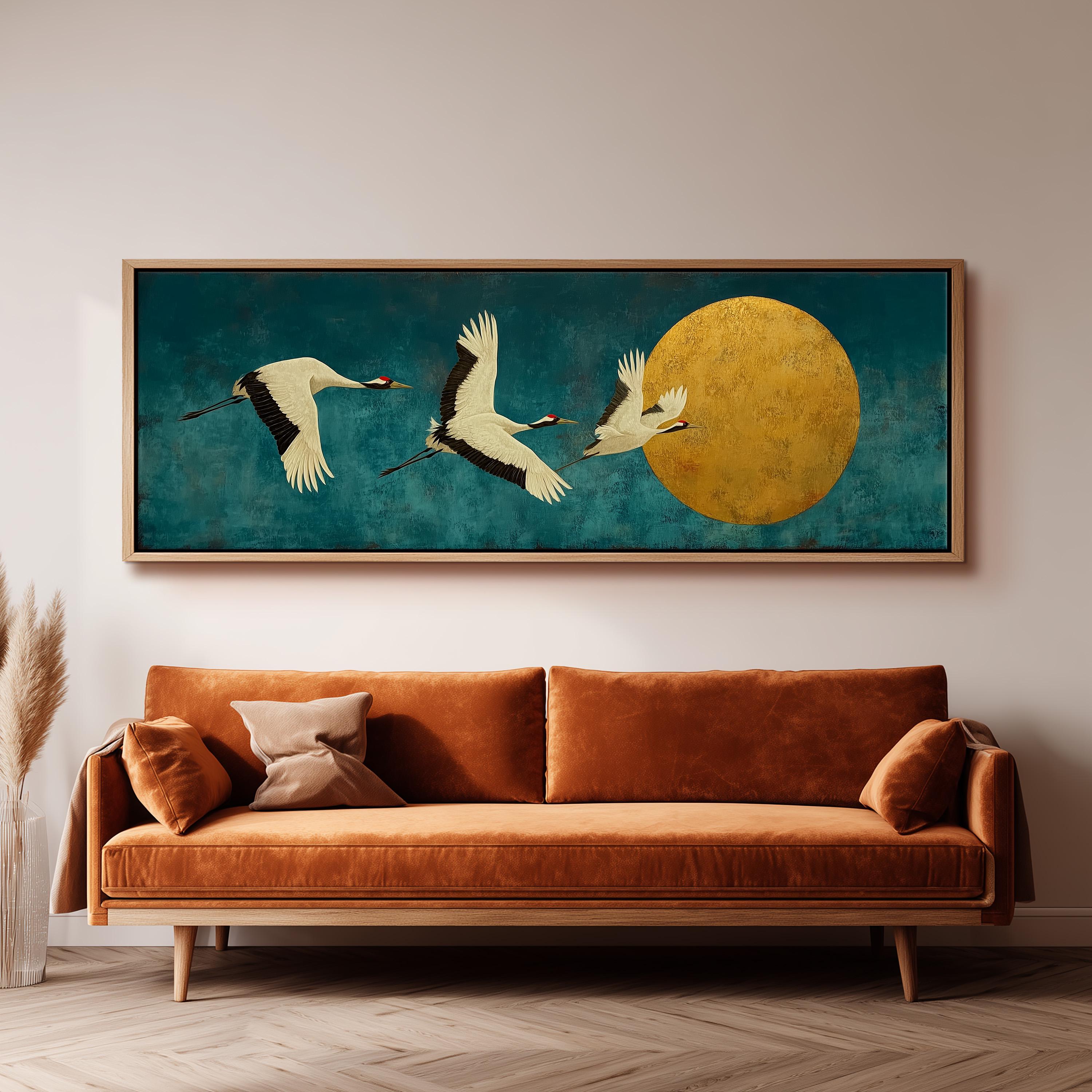 a large, framed painting of three white birds in flight against a blue background, with a large yellow circle in the center. The painting is hanging on a wall above a brown sofa.
