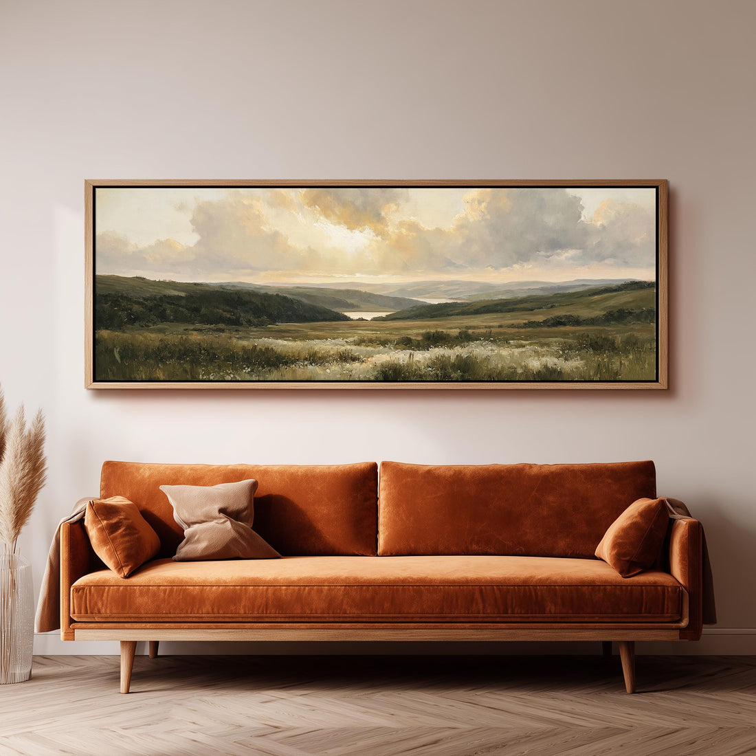 Rolling hills and a lake at golden sunset long horizontal canvas print above a sofa in a living room