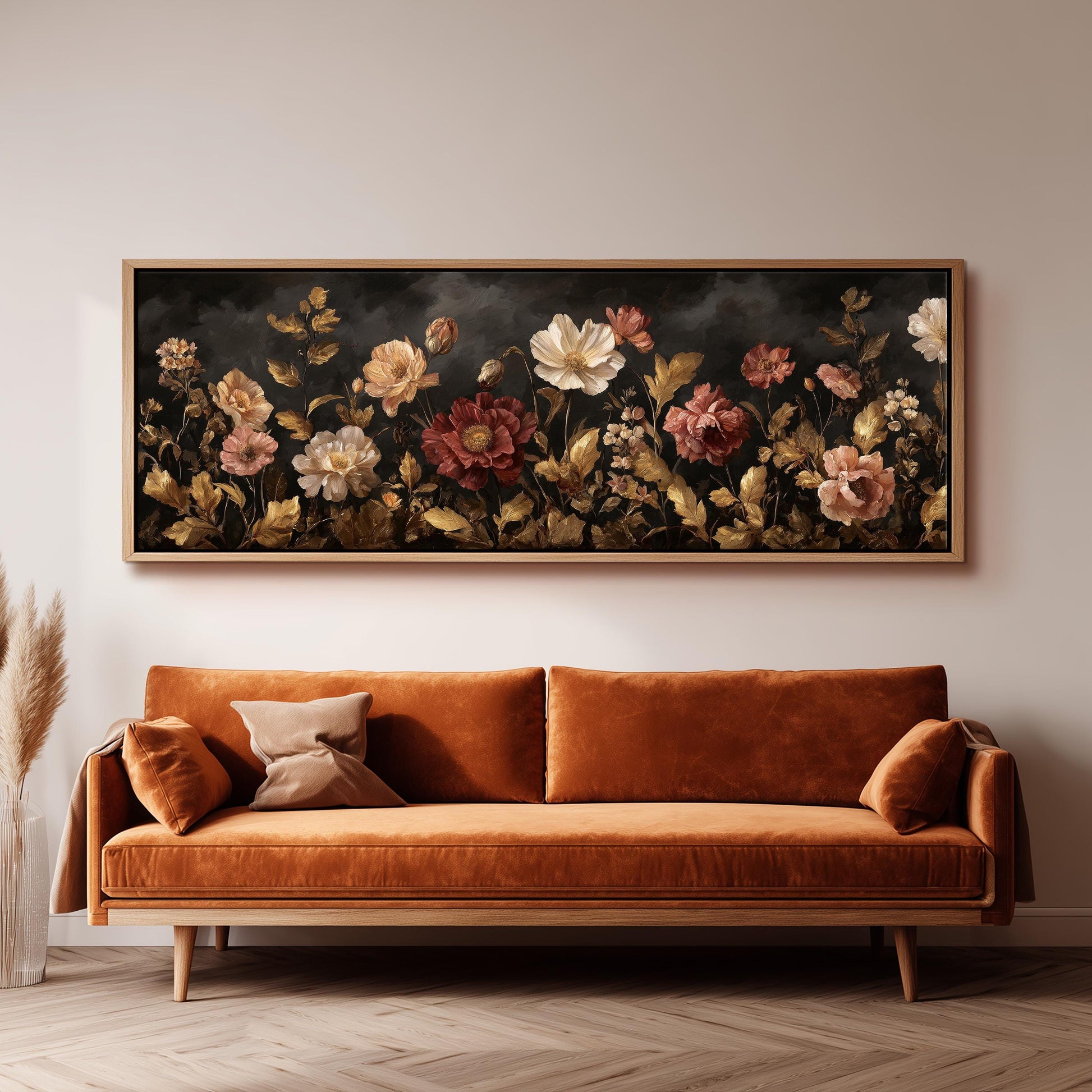 a large, ornate painting of flowers hanging on a wall above a brown sofa.