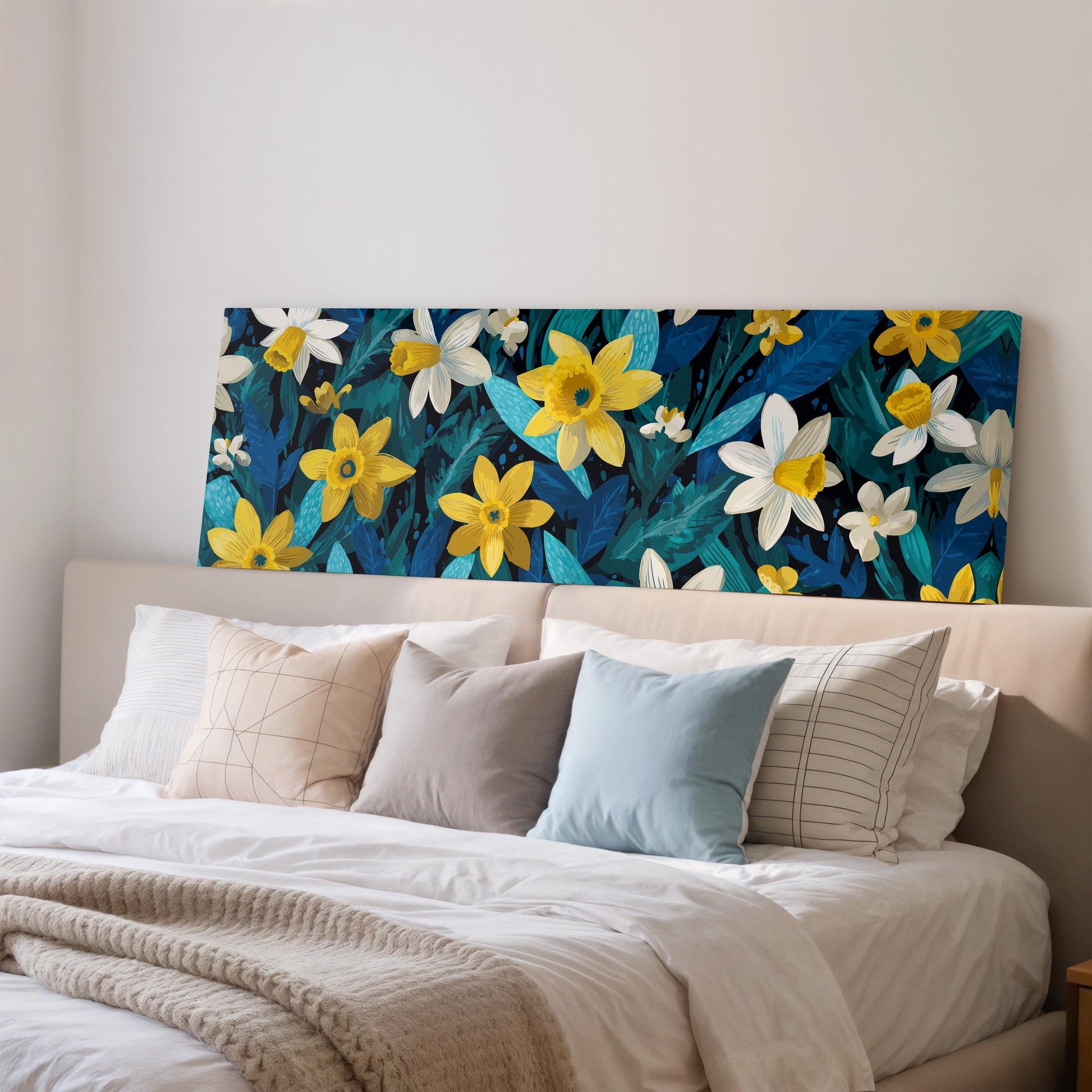 a large, colorful floral print displayed on the wall above a bed with white pillows and a gray blanket.