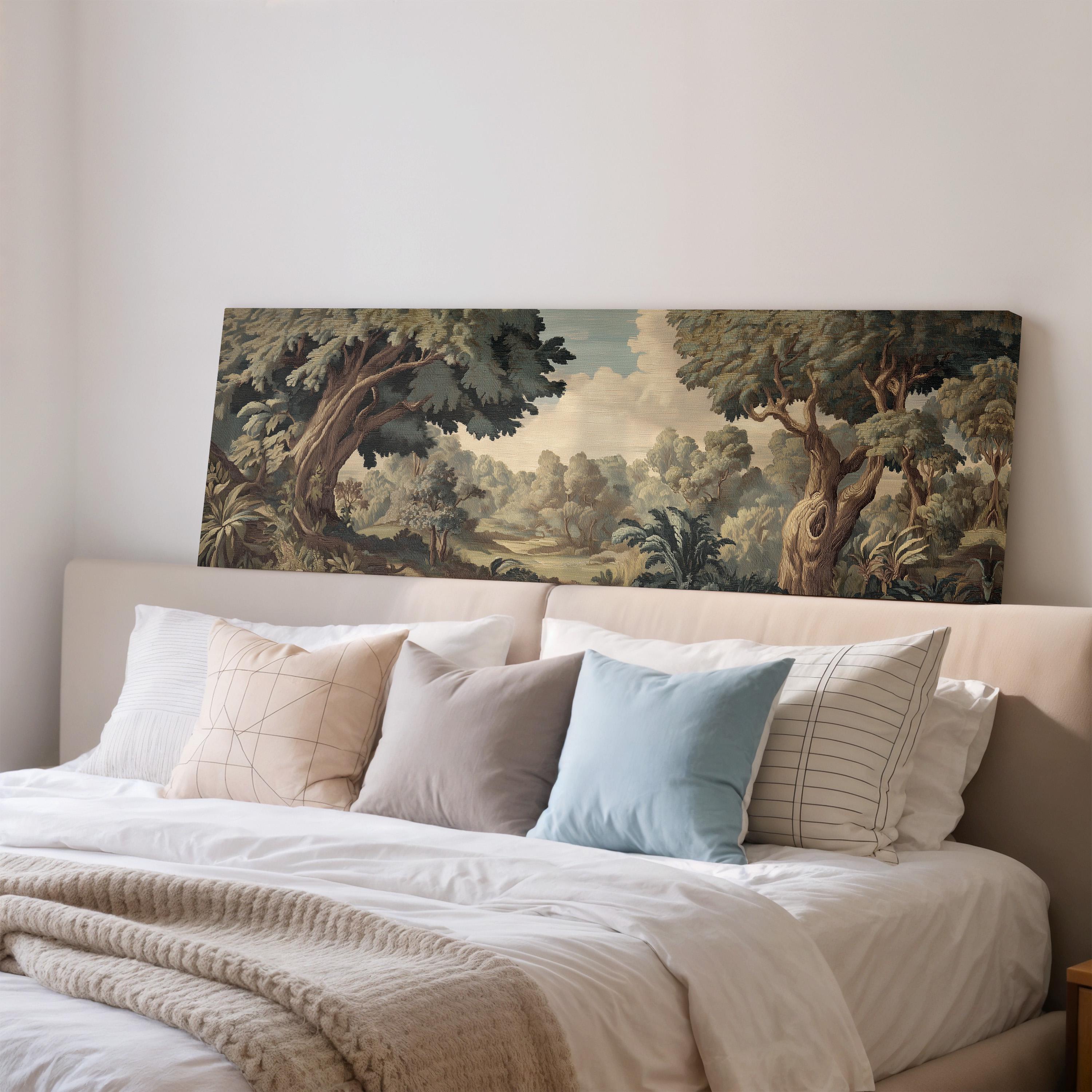 a large painting of a lush forest scene hanging on a wall above a bed with white bedding and various pillows.