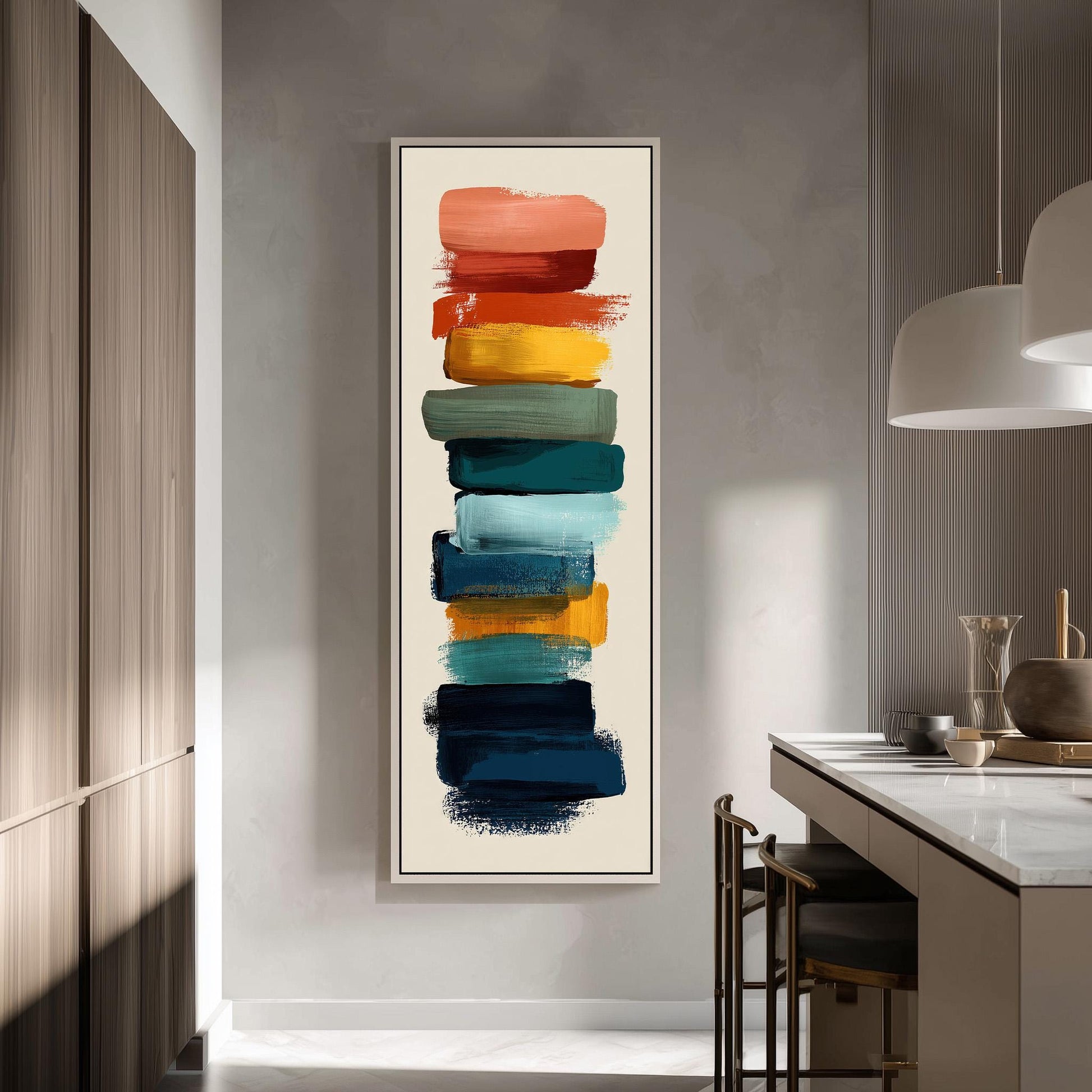 a modern kitchen with a large abstract painting hanging on the wall. The painting consists of a vertical arrangement of colorful brushstrokes in various shades of orange, yellow, green, blue, and purple. The kitchen is equipped with a white countertop and a sink, and there are chairs and a table in the room.