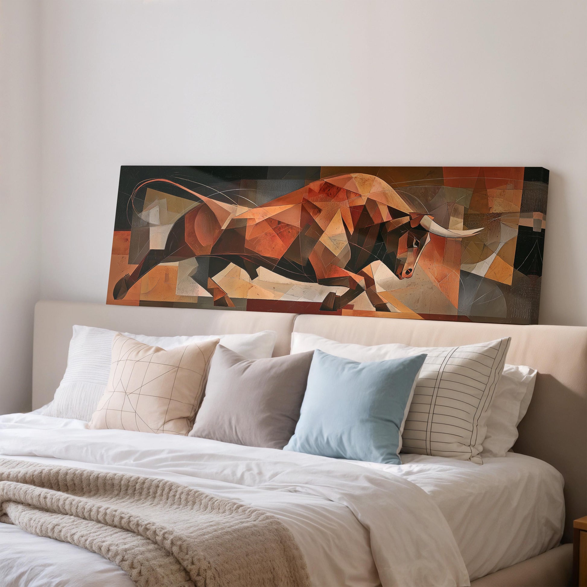 a large abstract painting of a bull on a bed, with a white headboard and bedding.