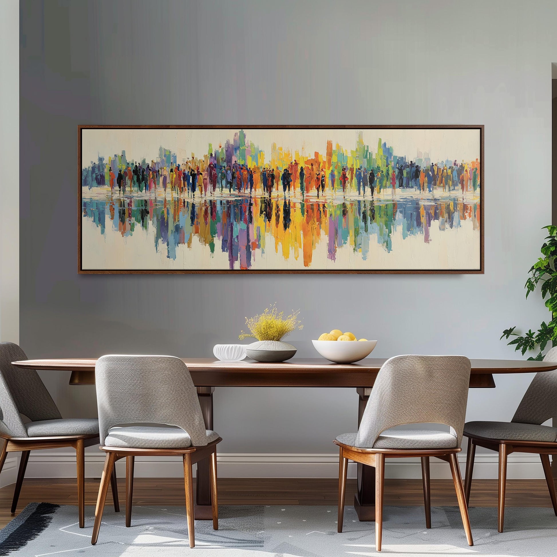 a dining room with a large, colorful painting hanging on the wall above a wooden dining table with four chairs. The table is set with a bowl of fruit and a vase of flowers, creating a welcoming and inviting atmosphere.