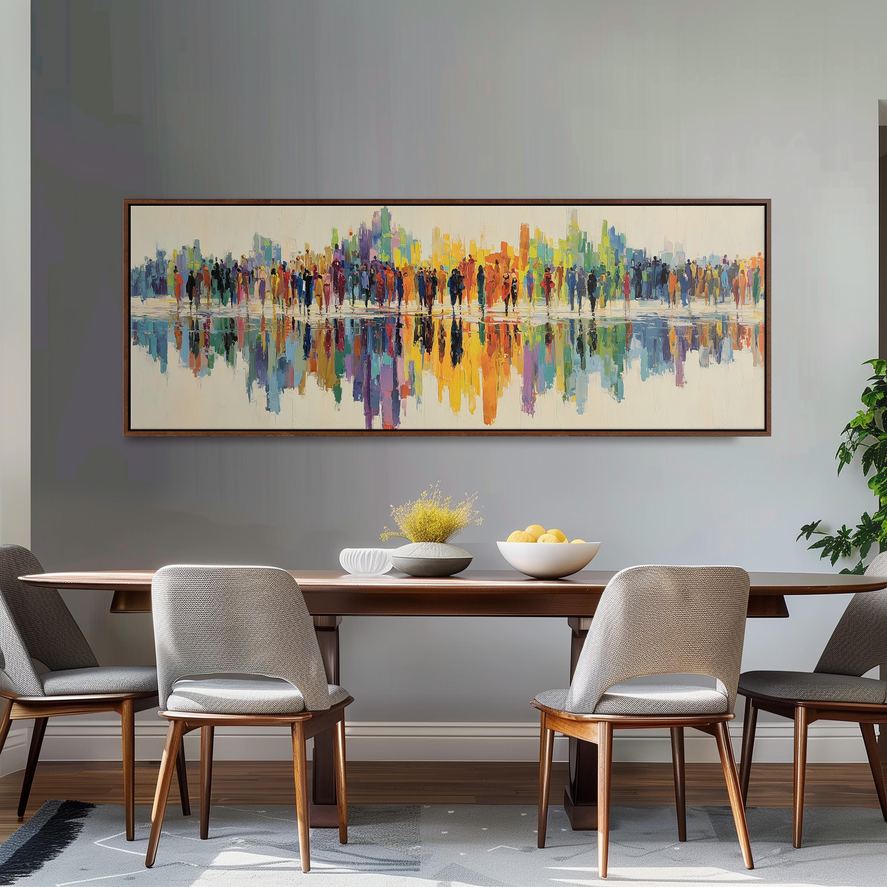 a dining room with a large, colorful painting hanging on the wall above a wooden dining table with four chairs. The table is set with a bowl of fruit and a vase of flowers, creating a welcoming and inviting atmosphere.