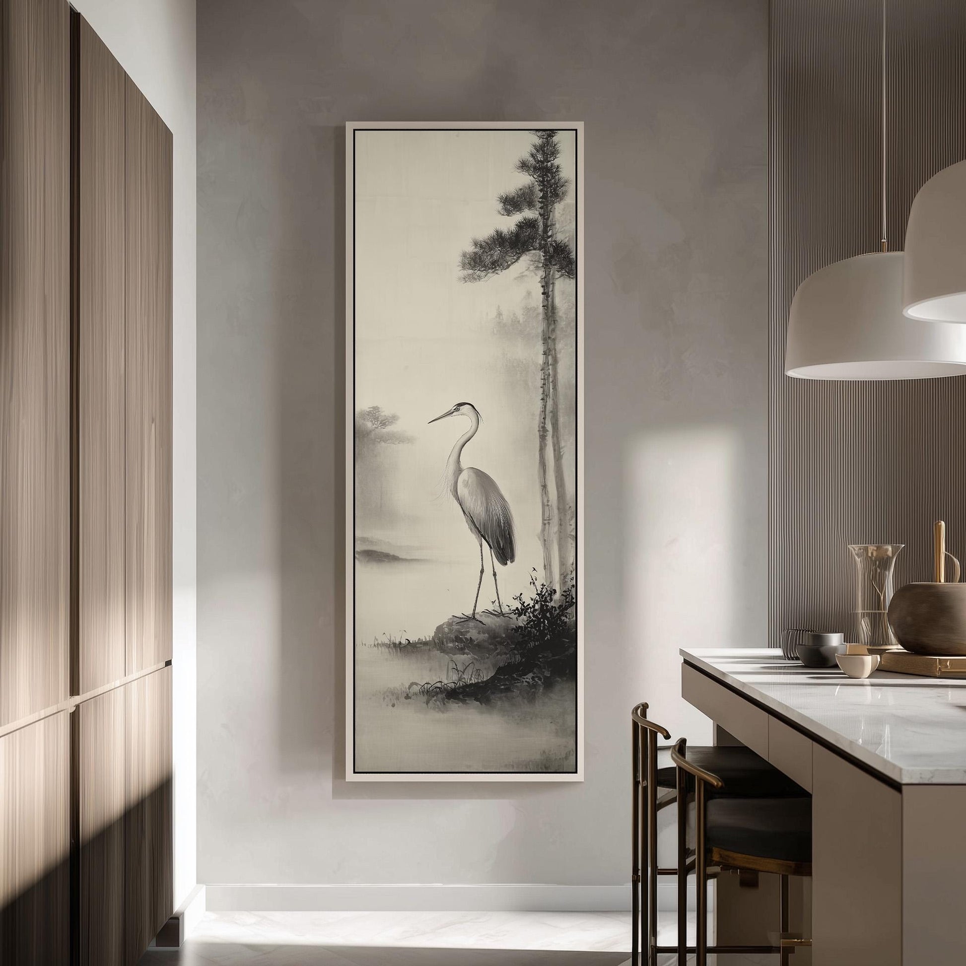 a large black and white painting of a crane standing on a rock, hanging on a wall in a modern kitchen.