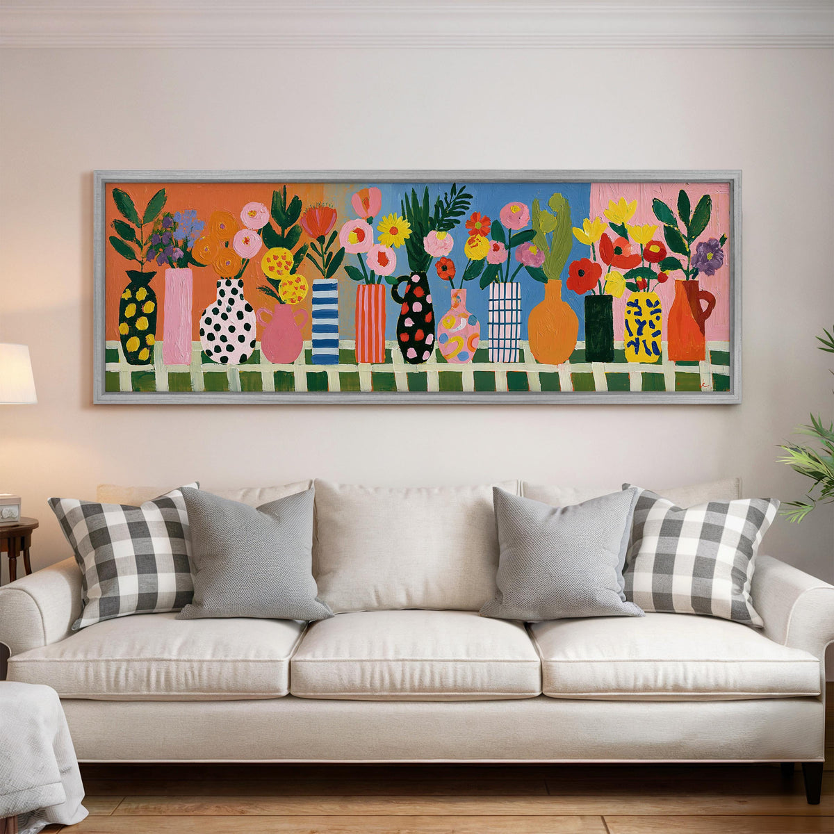 Patterned vases with bright bouquets panoramic canvas print above a white sofa in a bright living room