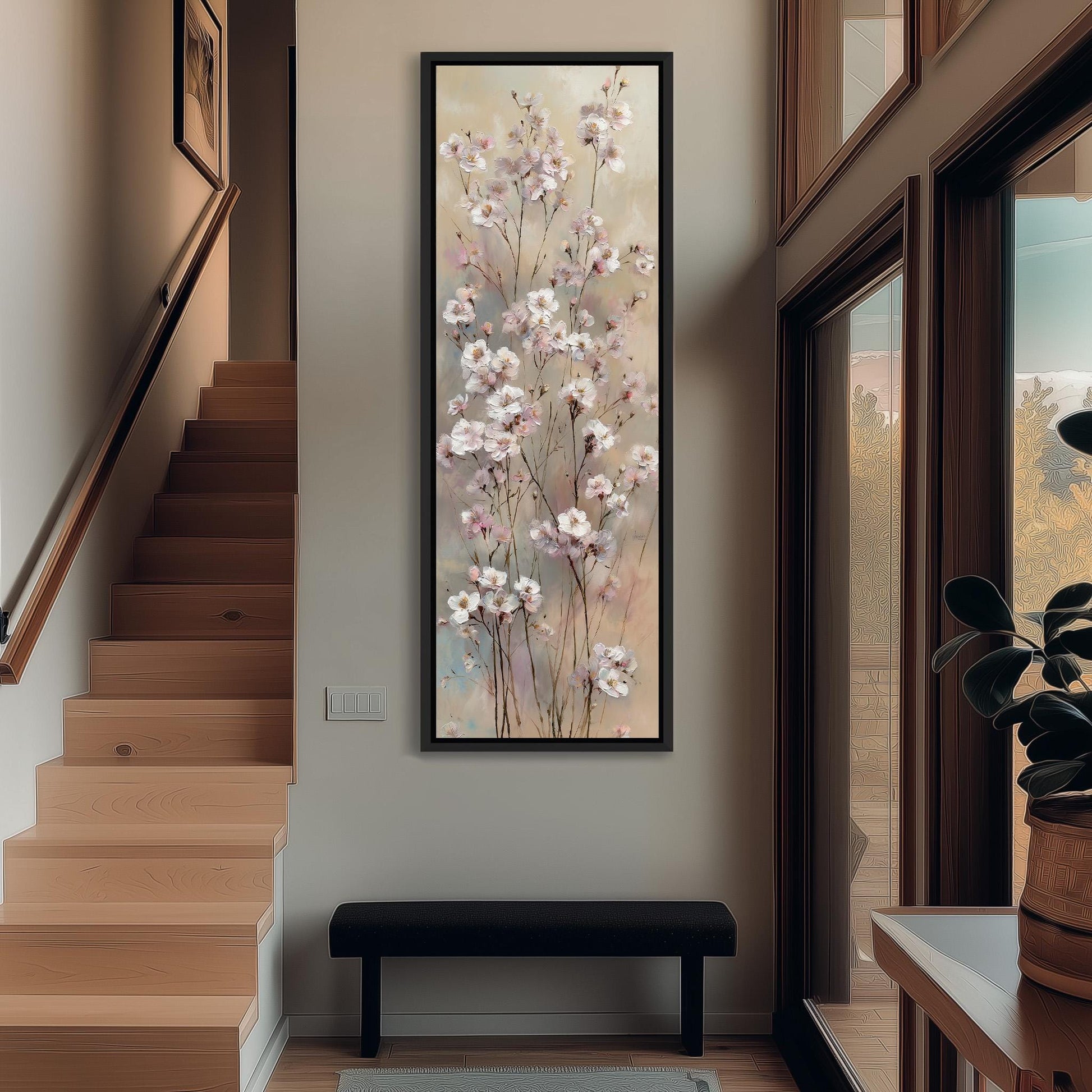 a large floral painting hanging on the wall of a hallway, with a wooden staircase and a bench in the foreground.