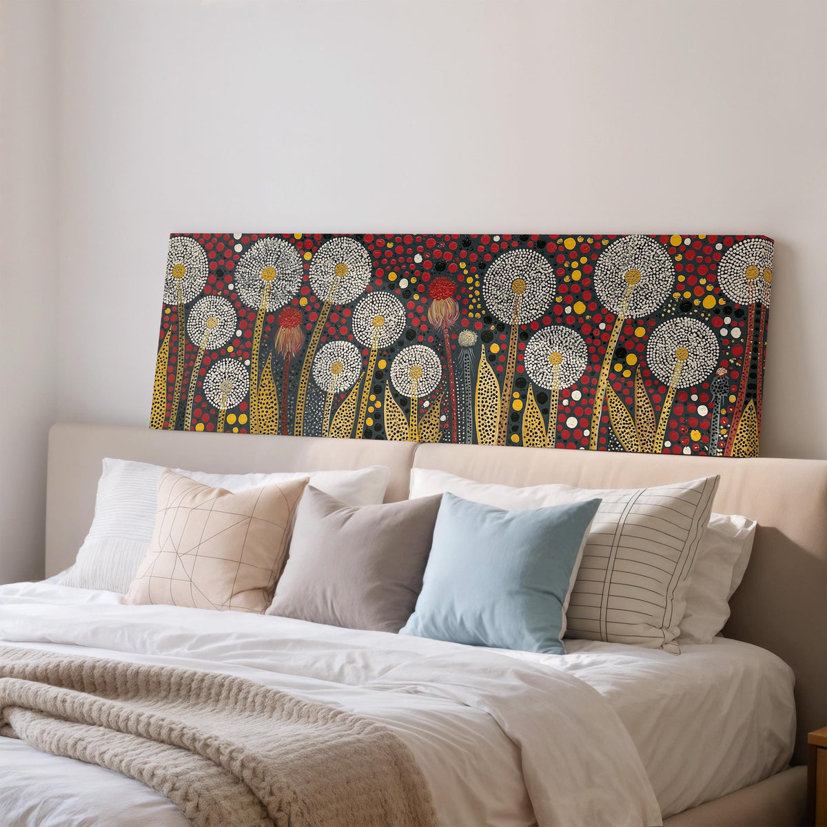 Dotted dandelions on deep red wide panoramic canvas print above a bed in a bedroom