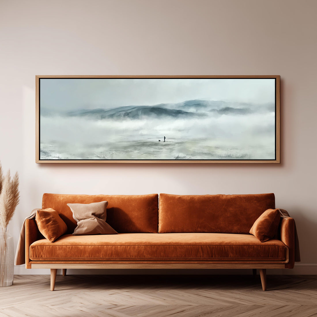 a large, framed painting of a landscape with a person standing in the middle of a misty, mountainous area.