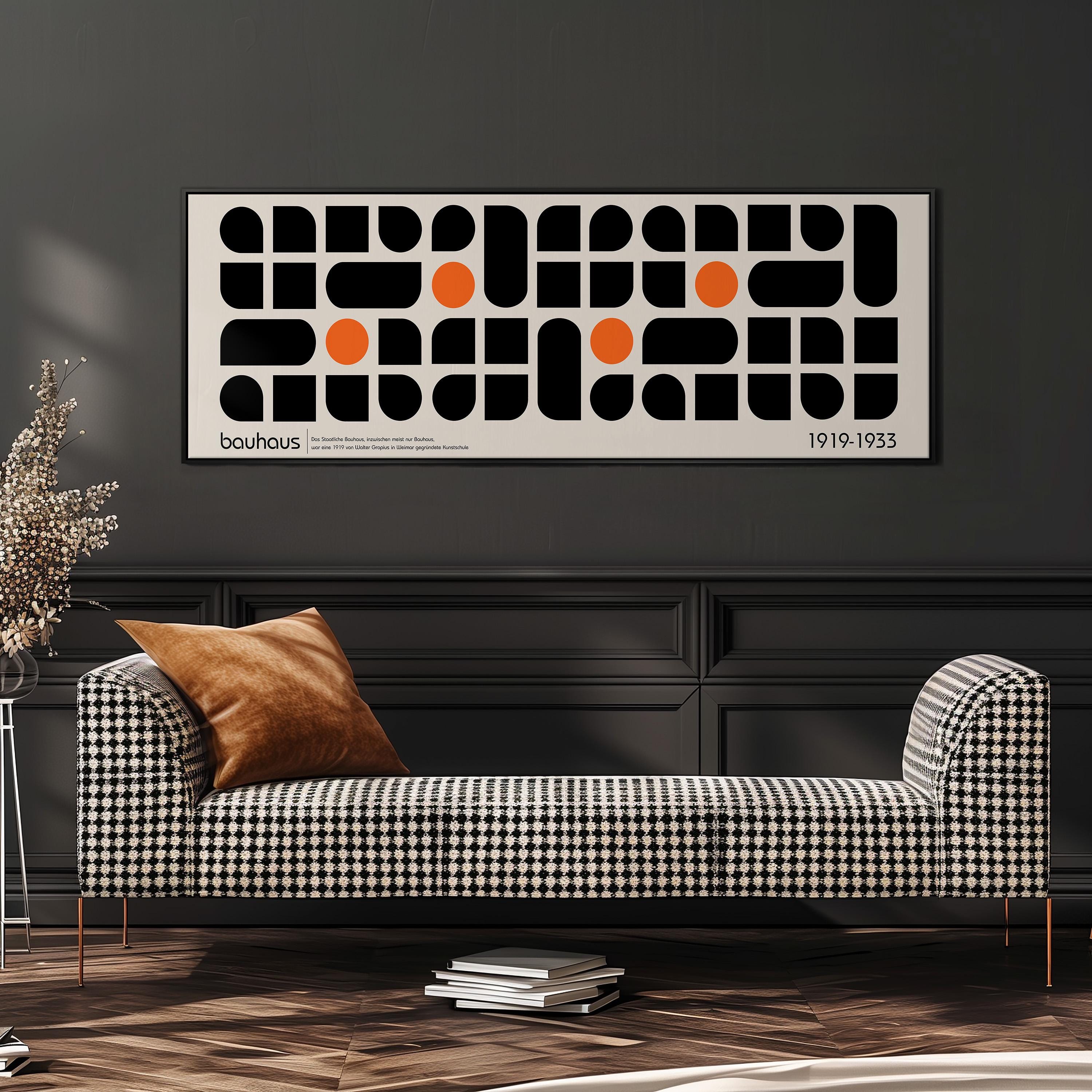 a modern living room with a black and white checkered sofa, a stack of books, and a large abstract art piece hanging on the wall above the sofa.