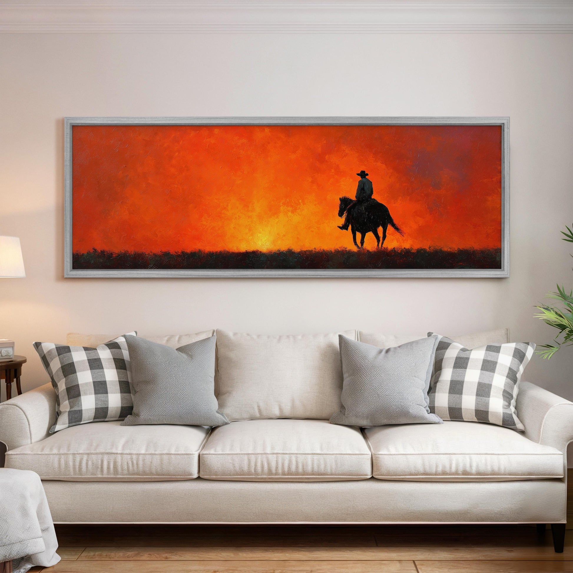 a large painting of a cowboy riding a horse, depicting a sunset over a field.