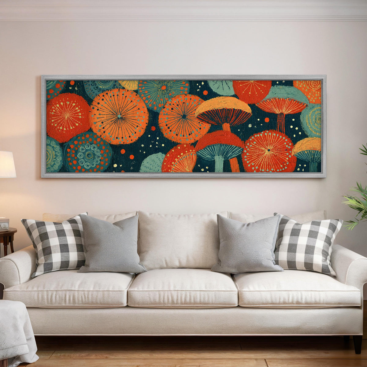 Orange and teal mushroom starburst panoramic canvas print above a white sofa in a bright living room