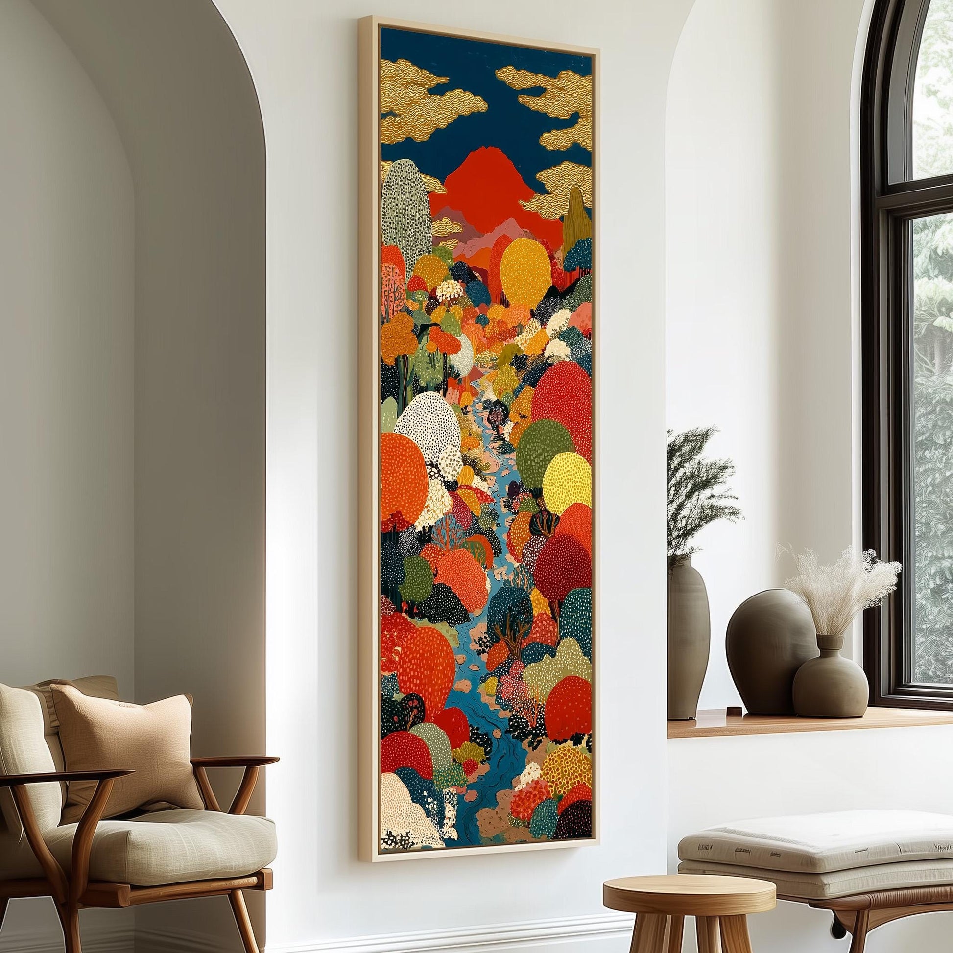 a large, colorful painting hanging on a wall in a room with a wooden chair and a small table.