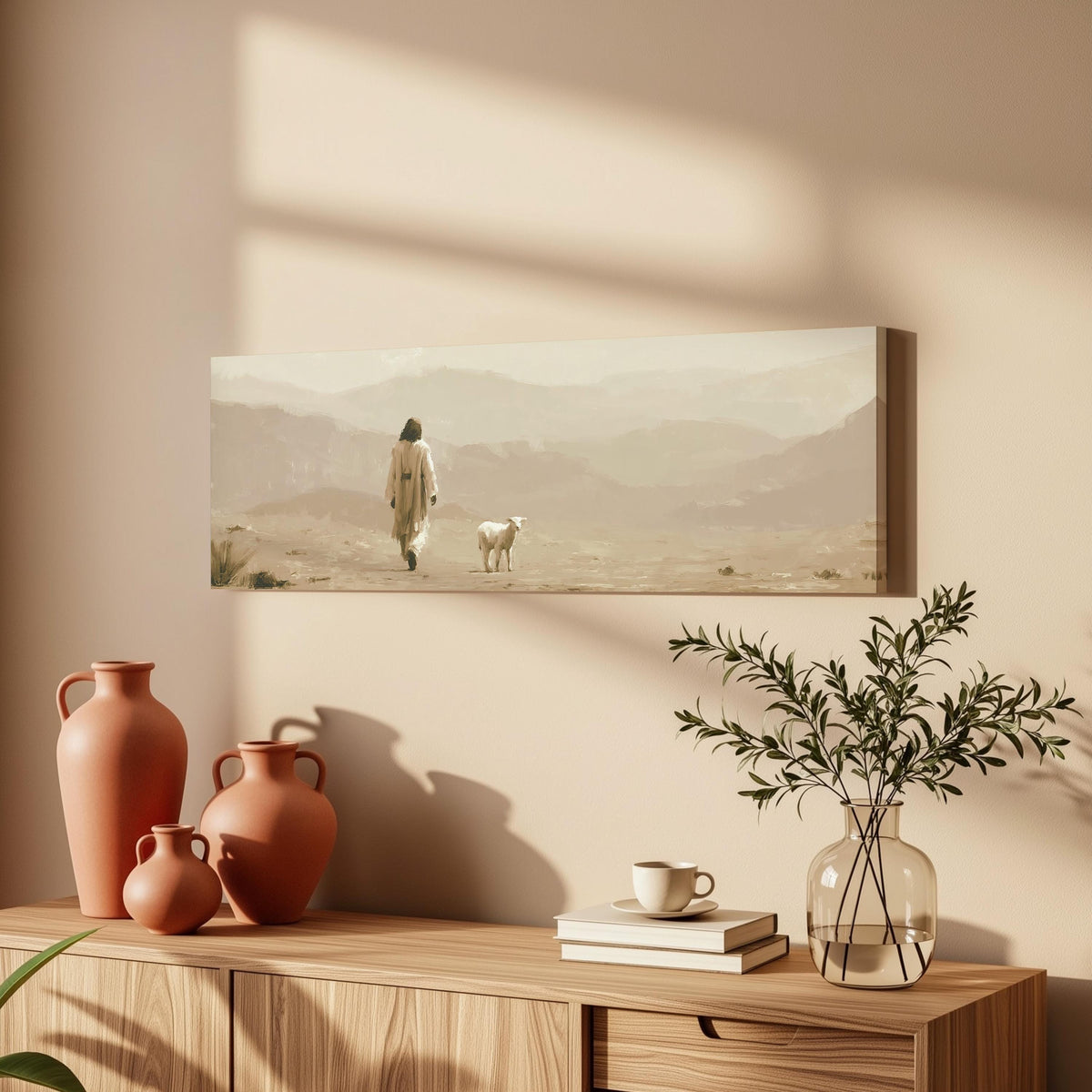 Jesus walking with a lamb through the desert long horizontal canvas print above a wooden sideboard