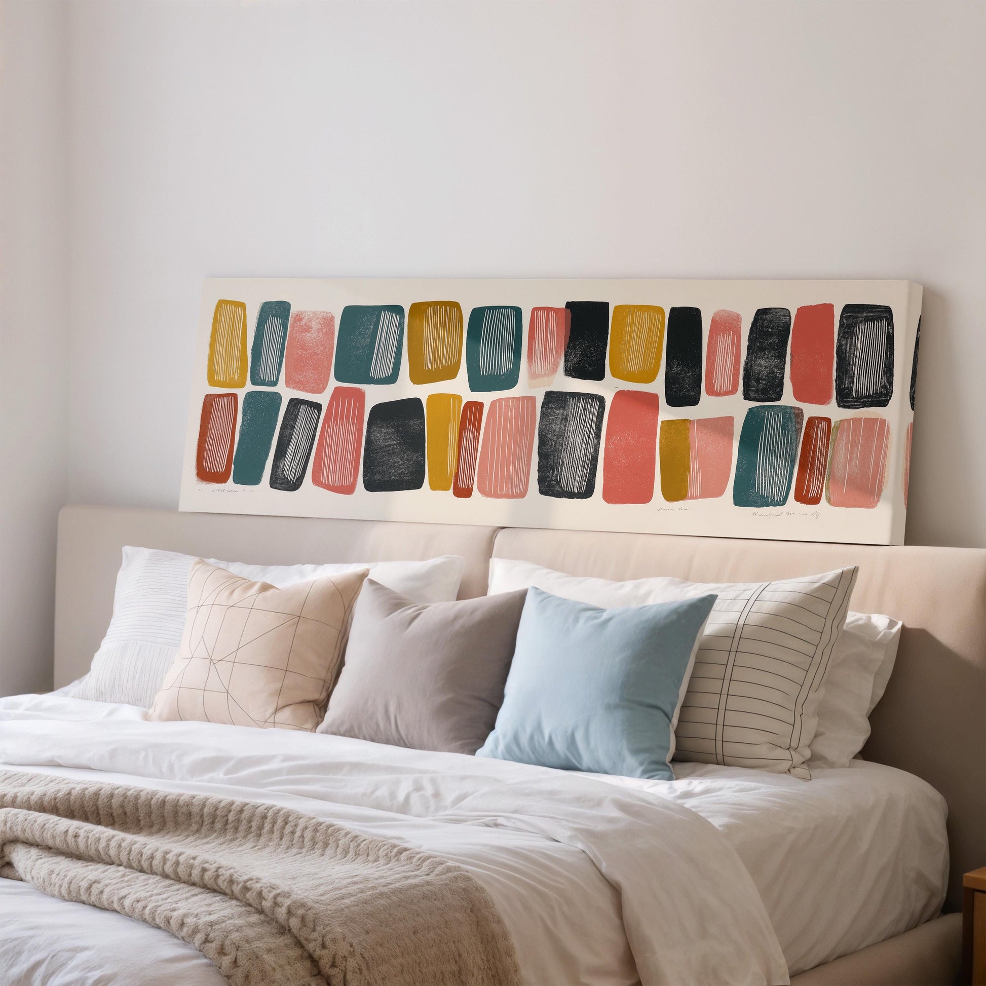 a well-made bed with a variety of colorful pillows and a large abstract painting on the wall above it.