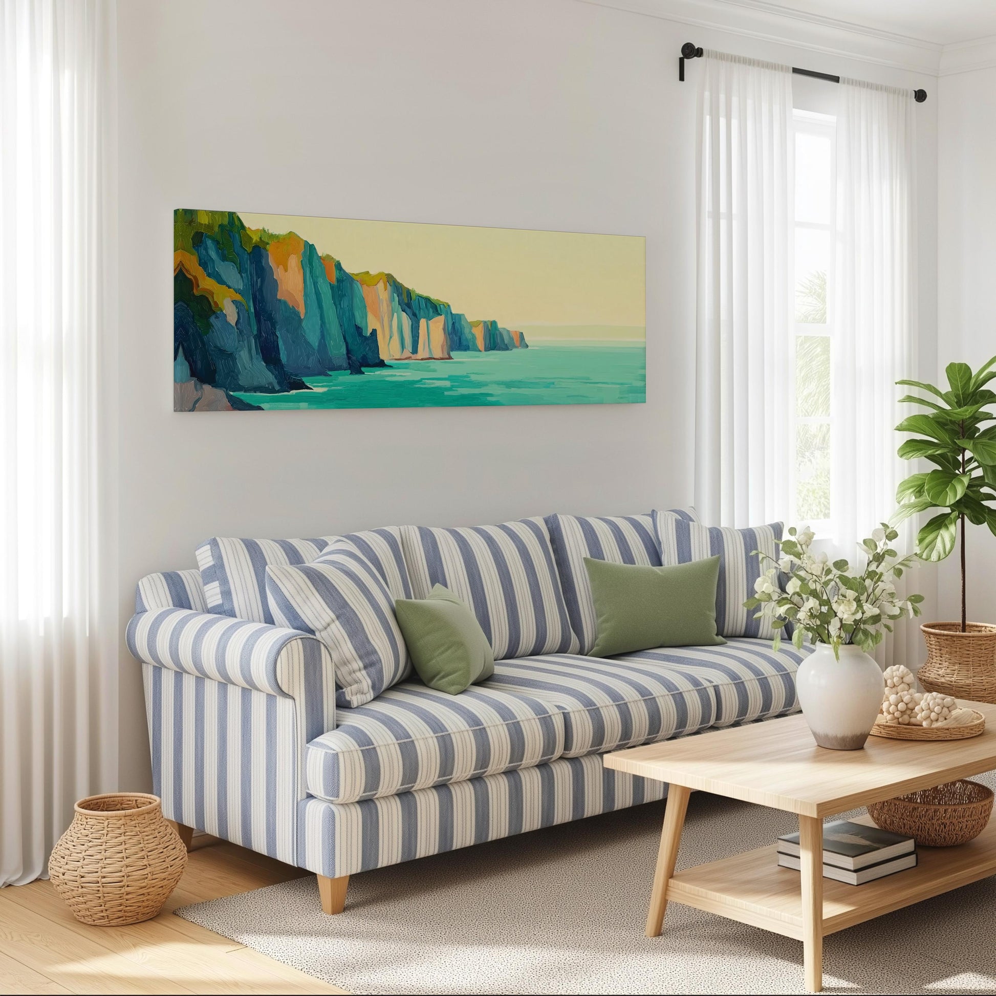 a cozy living room with a striped blue and white sofa, a wooden coffee table, and a large window with white curtains. Above the sofa, there is a large painting of a coastal landscape with cliffs and the ocean.