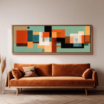 a large abstract painting hanging on a wall above a brown sofa with two pillows.