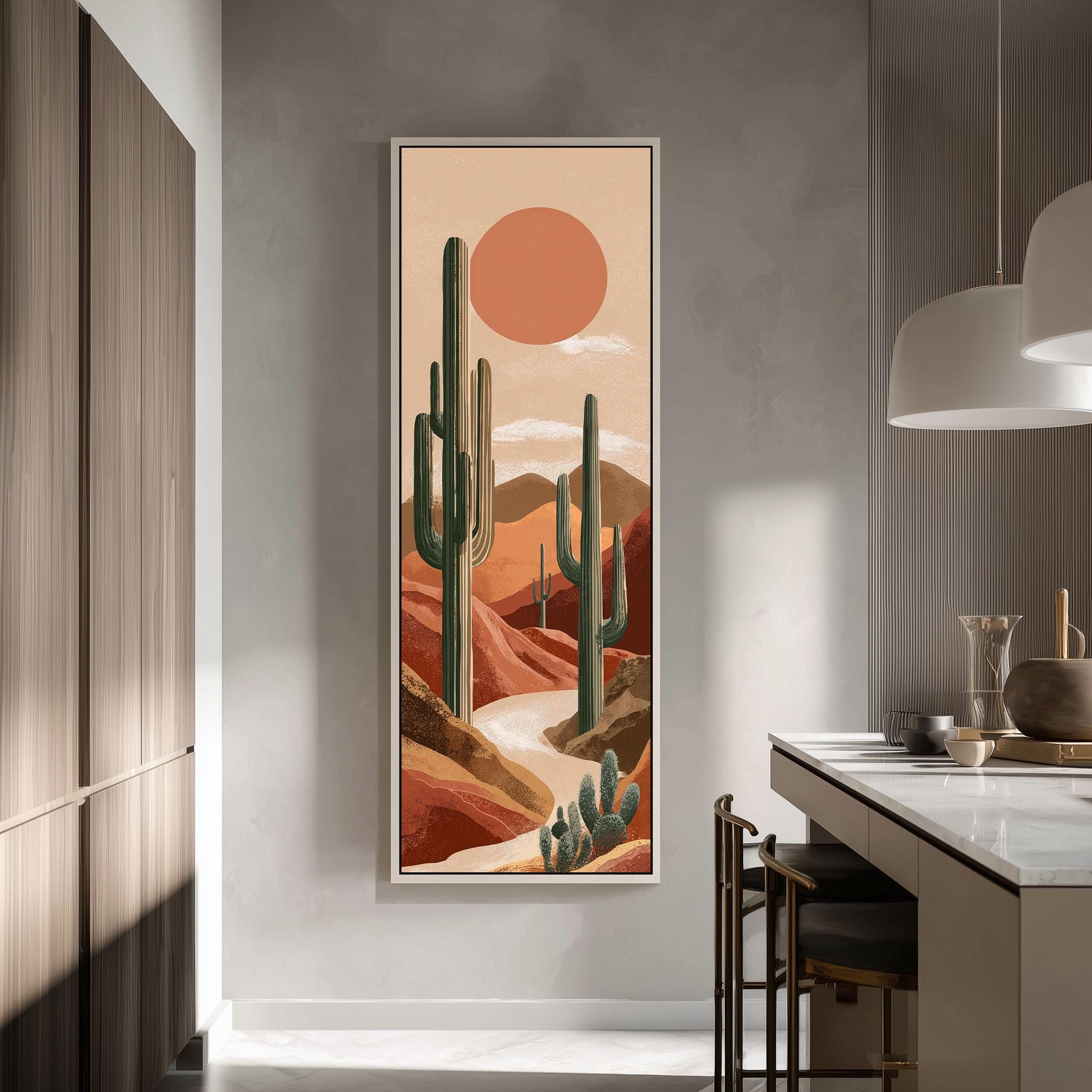 a large framed painting of a desert landscape with cacti and mountains in the background, hanging on a wall in a modern kitchen.