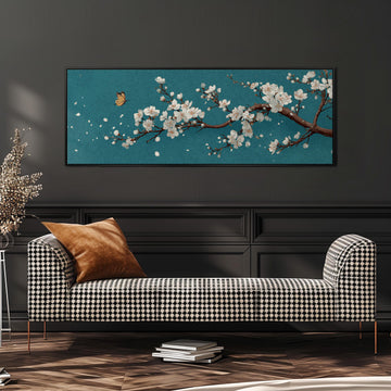 a black and white checkered sofa with a brown throw pillow, set against a dark wall with a large framed painting of a cherry blossom tree above it.