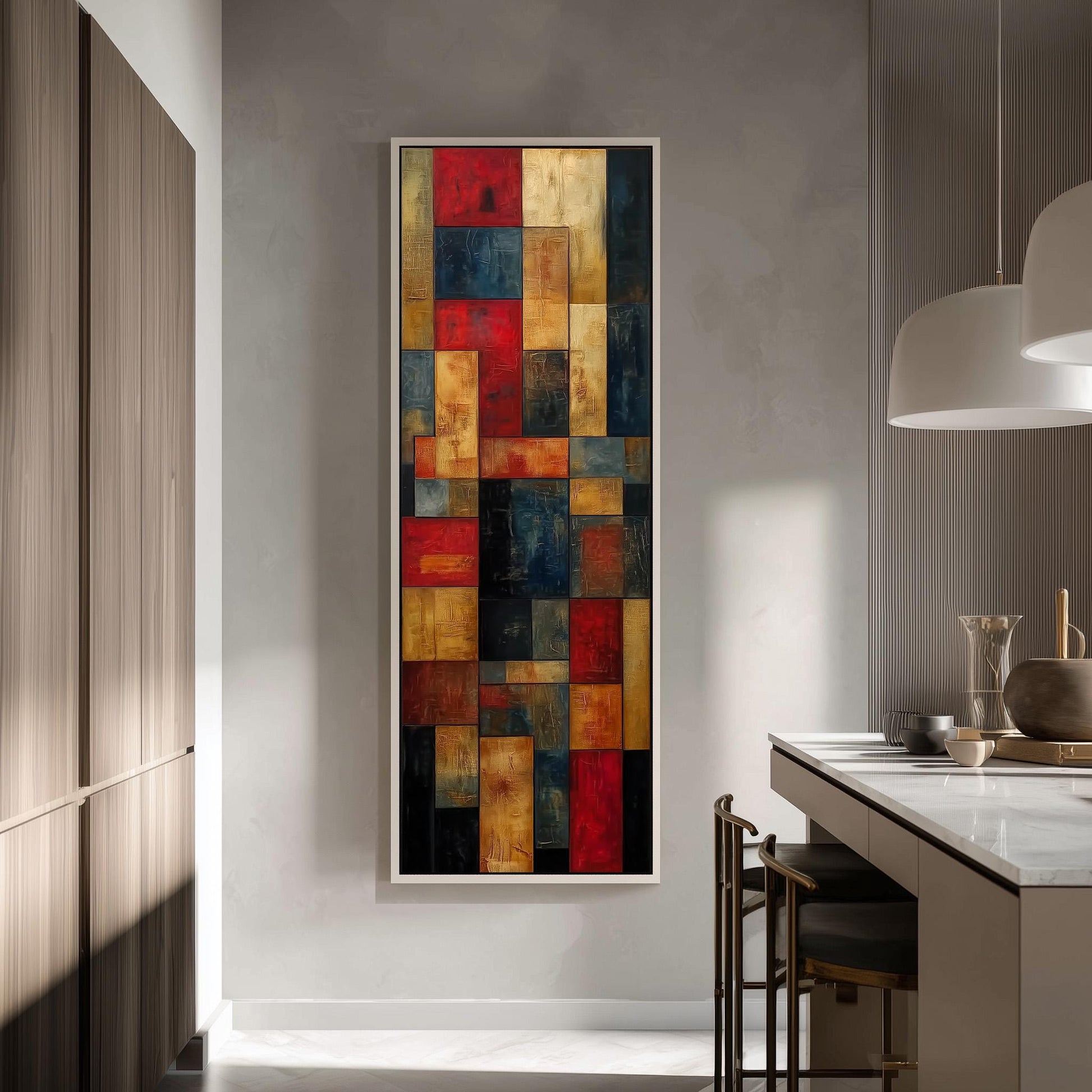 a modern kitchen with a large abstract painting hanging on the wall above a counter. The painting has a vibrant mix of red, yellow, blue, and orange squares, creating a visually striking contrast against the neutral tones of the kitchen.